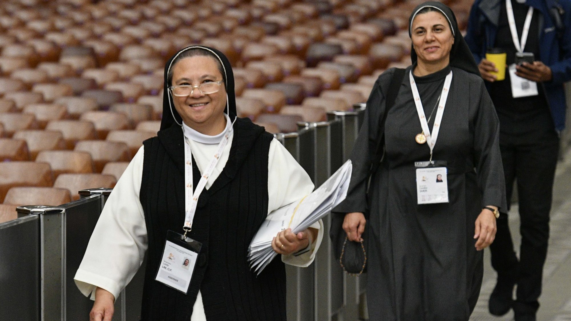 Sister Loida Lim, a member of the Missionaries of St. Dominic, and Sister Caroline Saheed Jarjis, a member of the Daughters of the Sacred Heart of Jesus, arrive for the afternoon session of the assembly of the Synod of Bishops in the Paul VI Audience Hall at the Vatican Oct. 13, 2023. (CNS/Vatican Media)