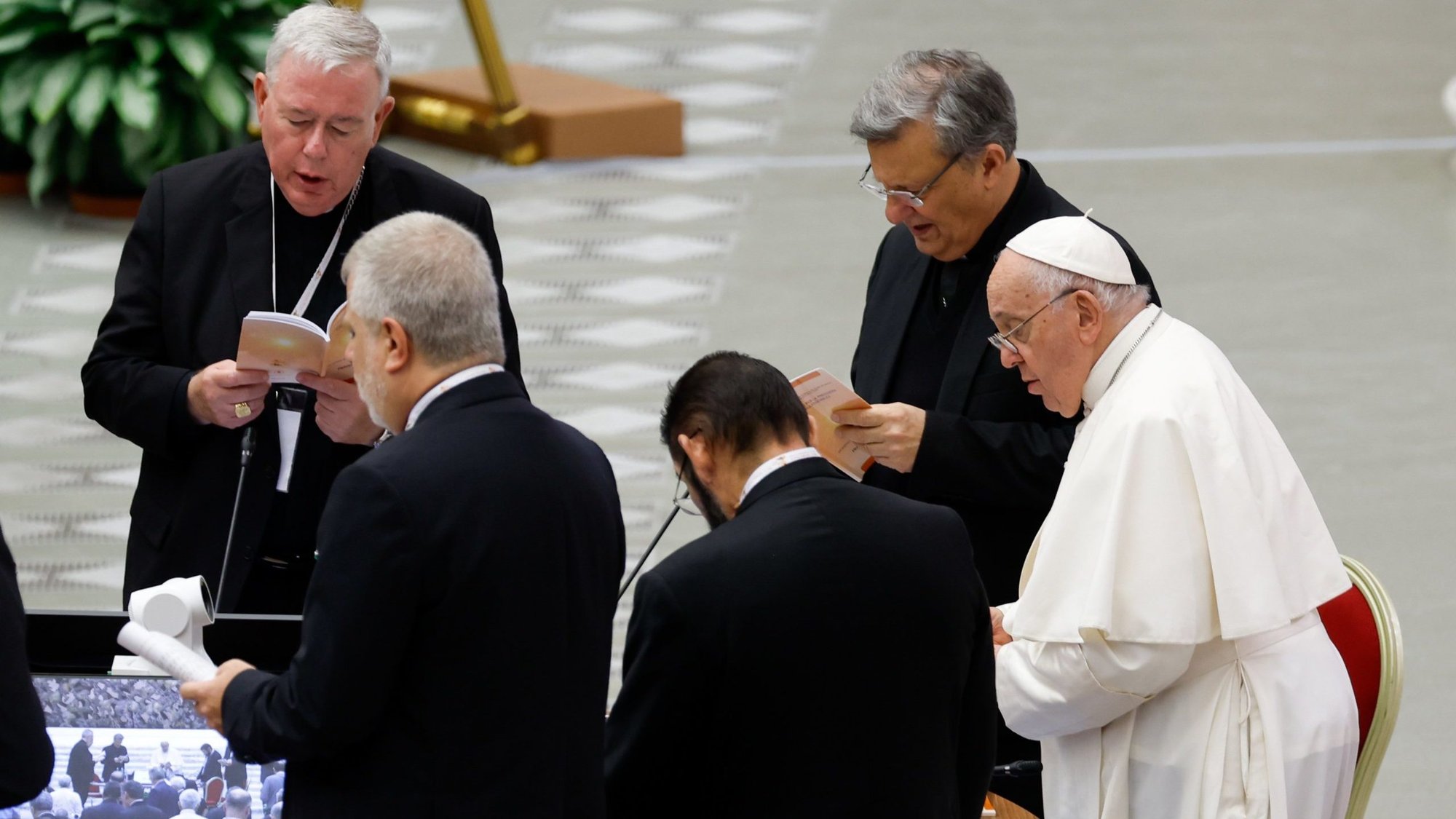 Pope Francis joins leaders of the assembly of the Synod of Bishops for prayer before a working session in the Vatican's Paul VI Audience Hall Oct. 20, 2023. (CNS photo/Lola Gomez)
