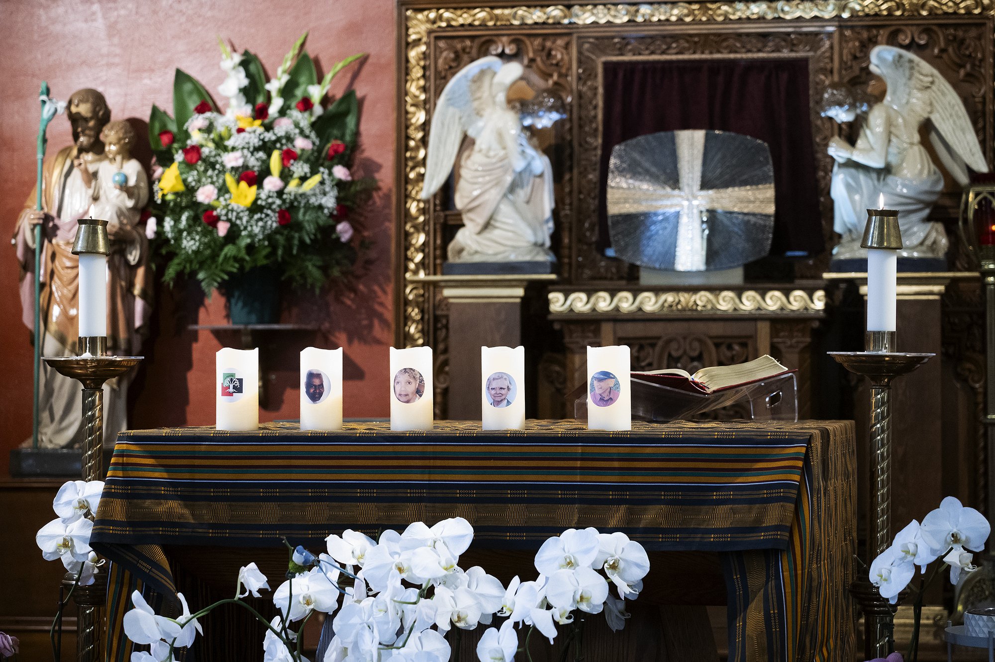 Candles featuring the photos of a deceased community member were placed on the altar at St. Odilia Church during the 14th annual African American Ancestral Mass on Nov. 11. (Victor Alemán)