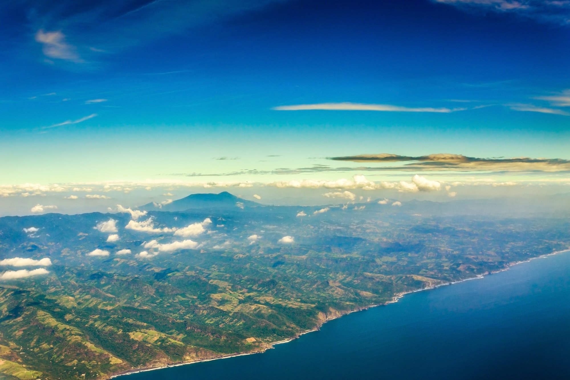 An aerial view out of an airplane window of the Pacific coast of El Salvador. (Shutterstock/Guayo Fuentes)