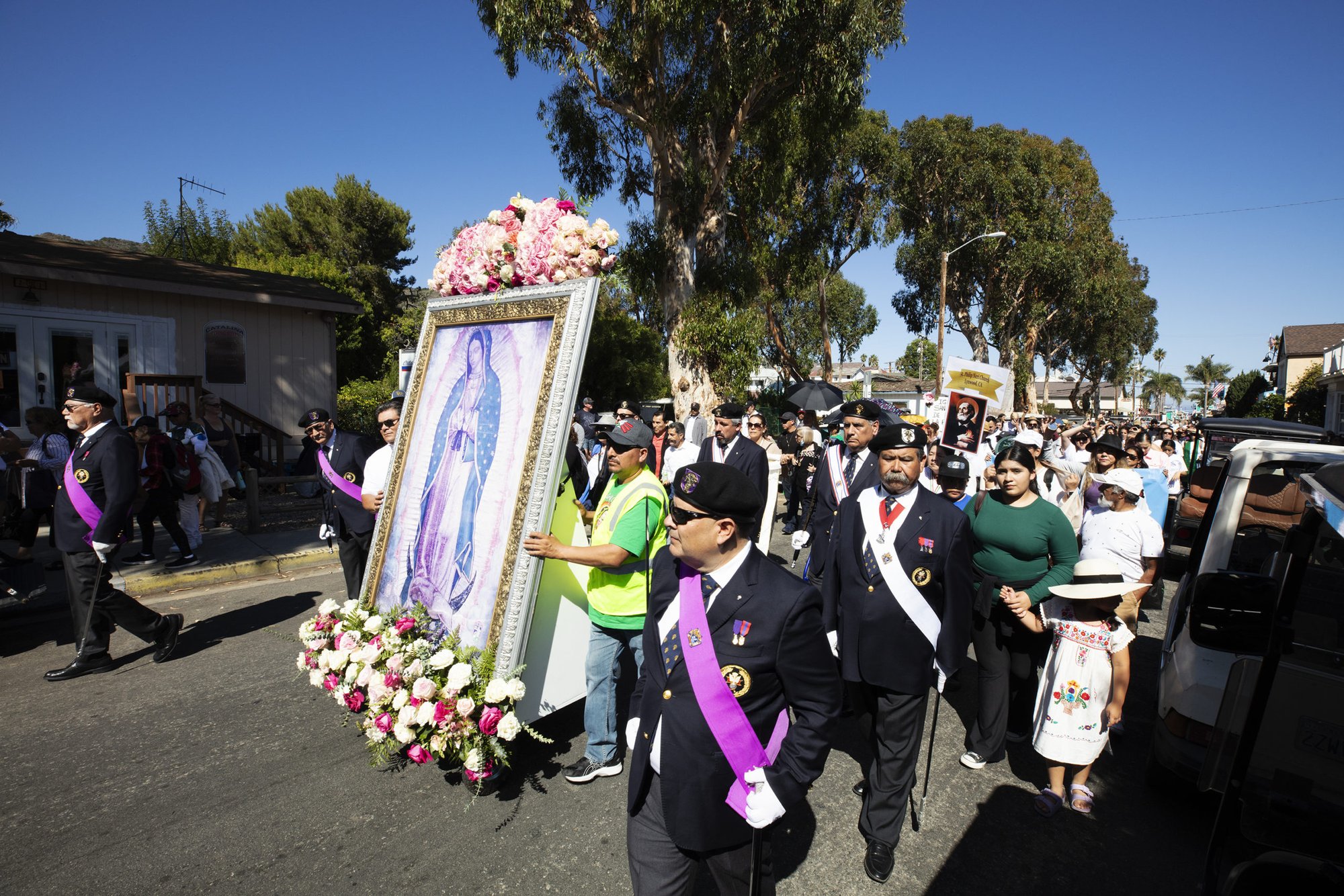 The faithful walk in a procession through Avalon on Catalina Island as the images of Our Lady of Guadalupe and St. Juan Diego began their multiparish pilgrimage through the Archdiocese of Los Angeles. (Victor Alemán)