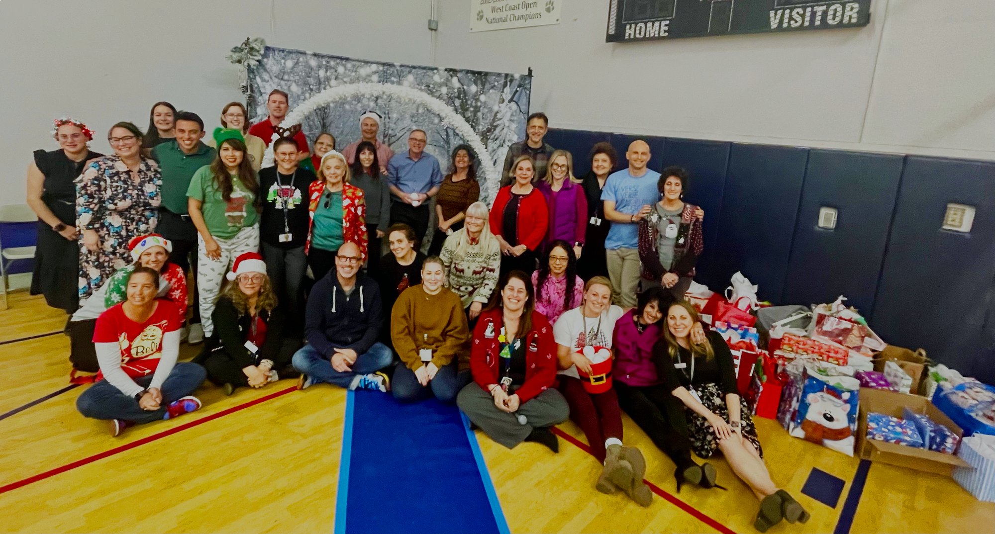 Staff at St. Francis de Sales Catholic School in Sherman Oaks pose with some of the gifts donated to help families. (Yannina Diaz)