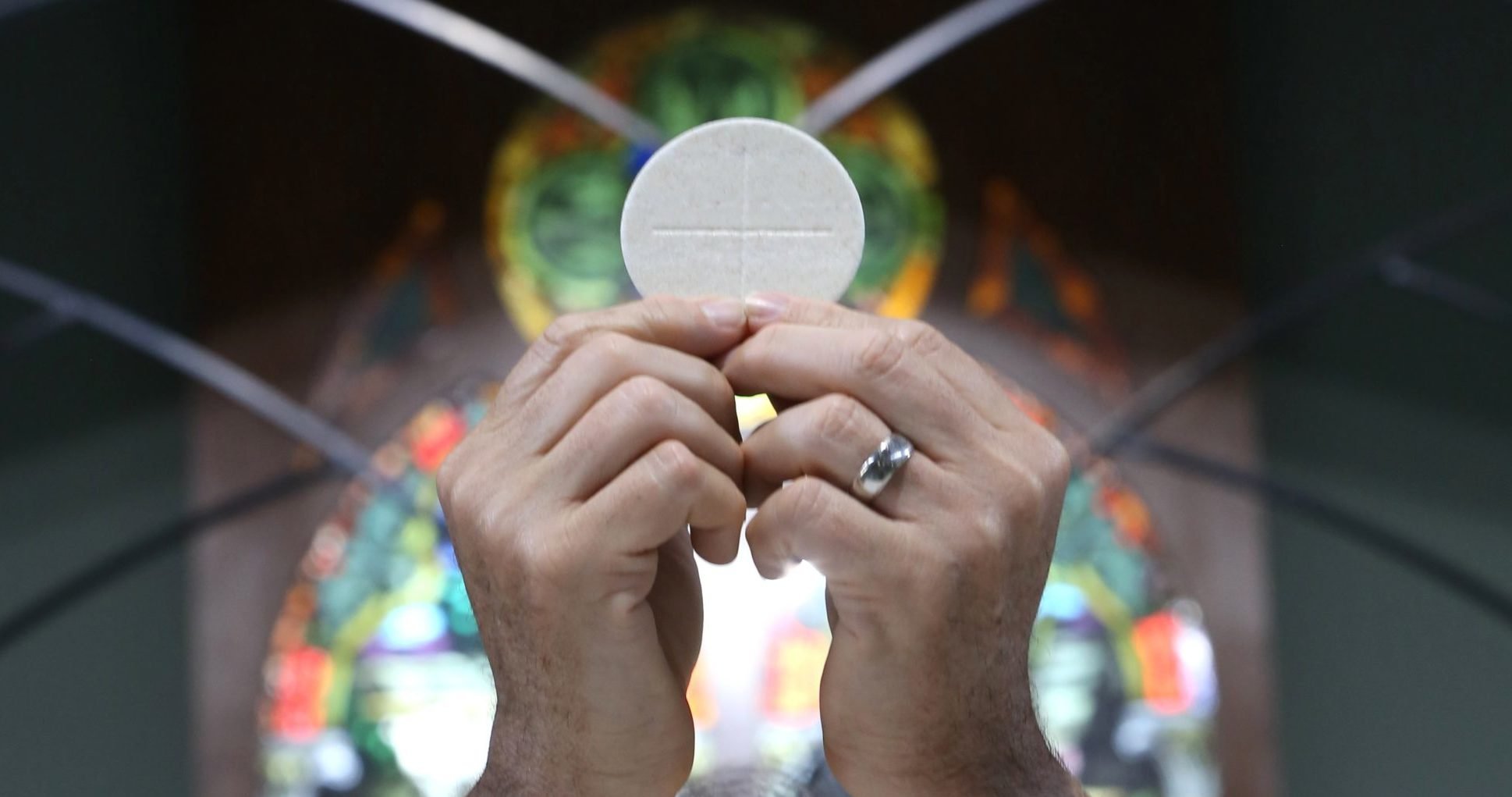 A priest raises the Eucharist in this illustration. (OSV News photo/CNS file, Bob Roller)