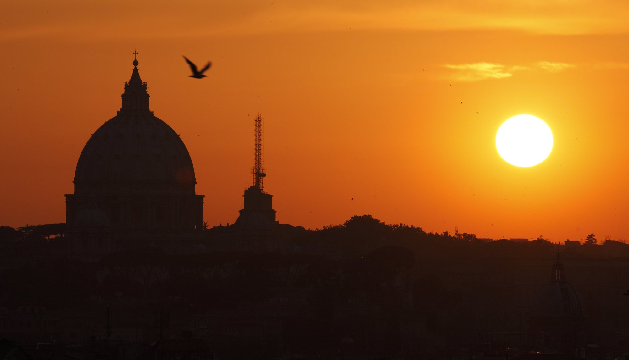 The dome of St. Peter’s Basilica at the Vatican is silhouetted as the sun sets in Rome. (CNS photo/Paul Haring)