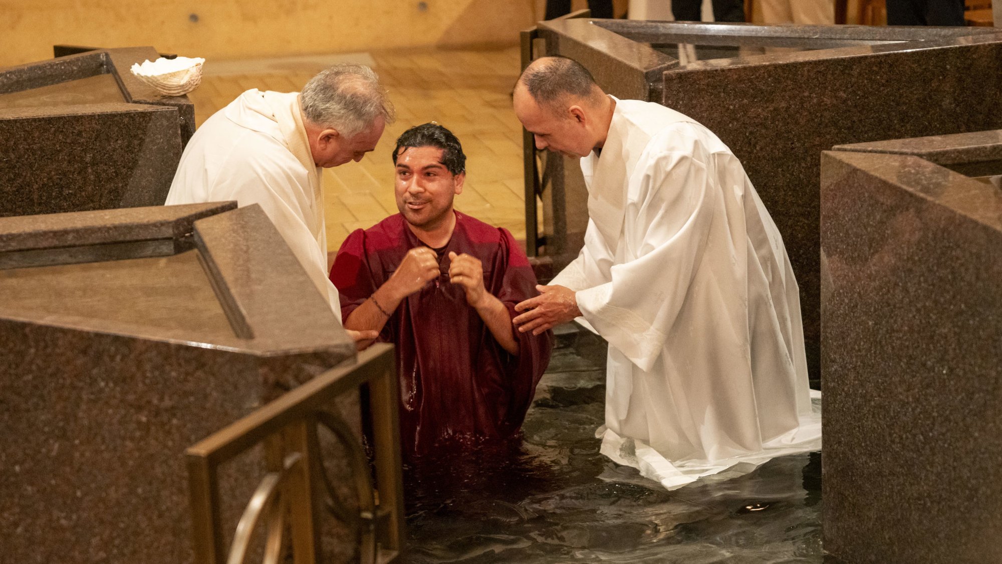 A catechumen is baptized at the Cathedral of Our Lady of the Angels during the 2024 Easter vigil on March 30. (John Rueda)