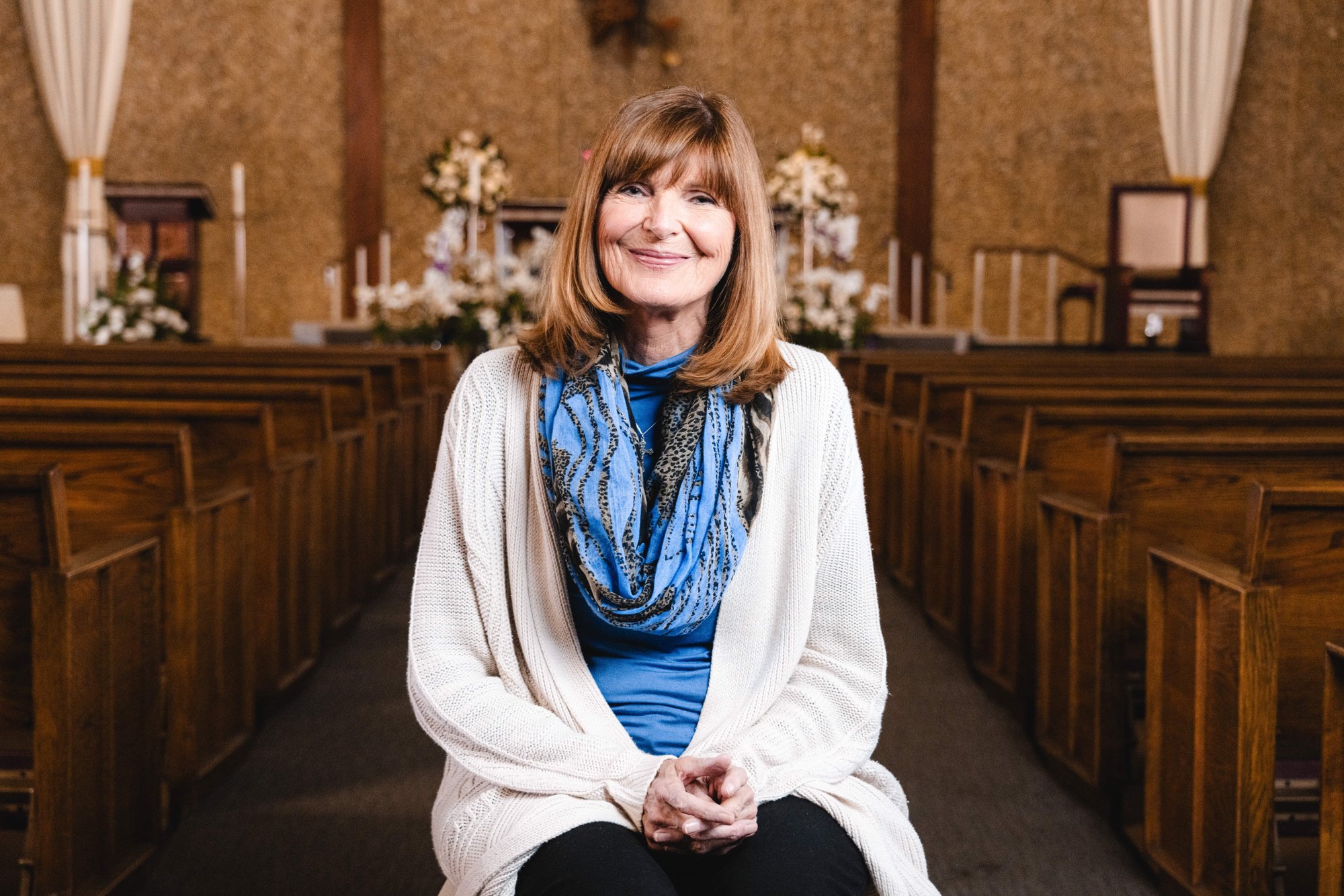 Kathleen Anderson sits inside St. Cornelius Church in Long Beach, where she is a longtime parishioner. (Isabel Cacho)