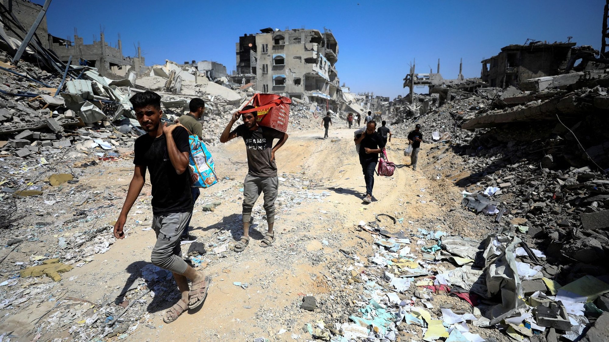 Palestinians make their way through the Shejaiya neighborhood in the eastern part of Gaza City July 10, 2024, inspecting the damage after Israeli forces withdrew following a ground operation amid the ongoing Israel-Hamas conflict. (OSV News photo/Dawoud Abu Alkas, Reuters)