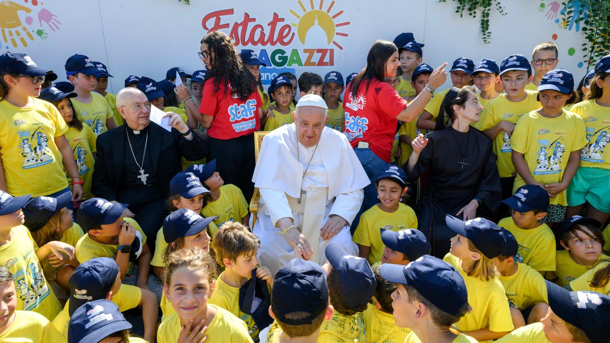 Pope Francis greets children of Vatican employees attending a summer camp at the Vatican July 18, 2024. Also in the photo are, to the pope's left, Cardinal Fernando Vérgez Alzaga, president of the commission governing Vatican City State, and, to the pope's right, Sister Raffaella Petrini, secretary-general of the commission and a member of the Franciscan Sisters of the Eucharist. (CNS photo/Vatican Media)