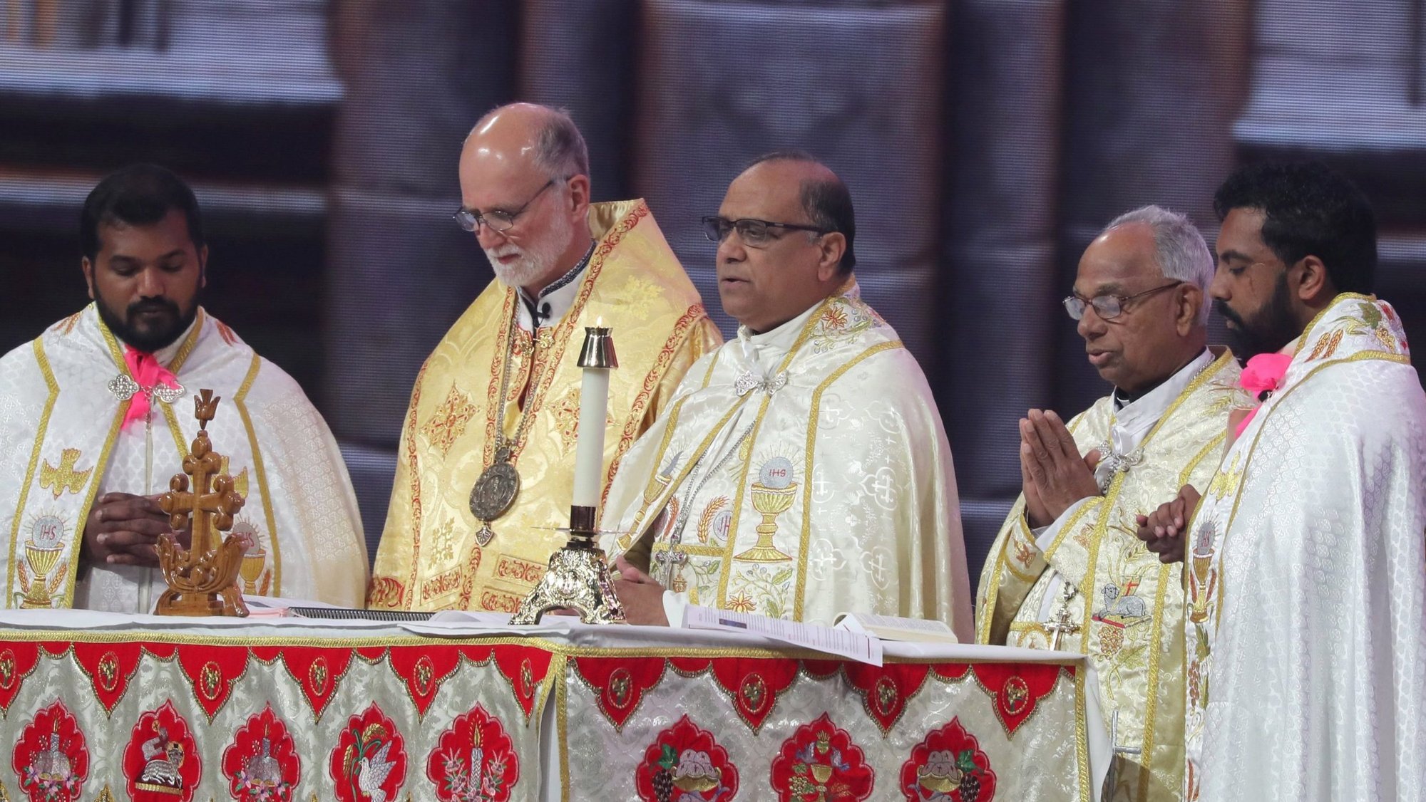 Syro-Malabar Bishop Joy Alappatt, center, and Metropolitan Archbishop Borys A. Gudziak of the Ukrainian Catholic Archeparchy of Philadelphia, in gold vestments, concelebrate Holy Qurbana July 20, 2024, in Lucas Oil Stadium in Indianapolis during the National Eucharistic Congress. Holy Qurbana is the name for Mass in the Catholic Church's Syro-Malabar rite. (OSV News photo/Bob Roller)