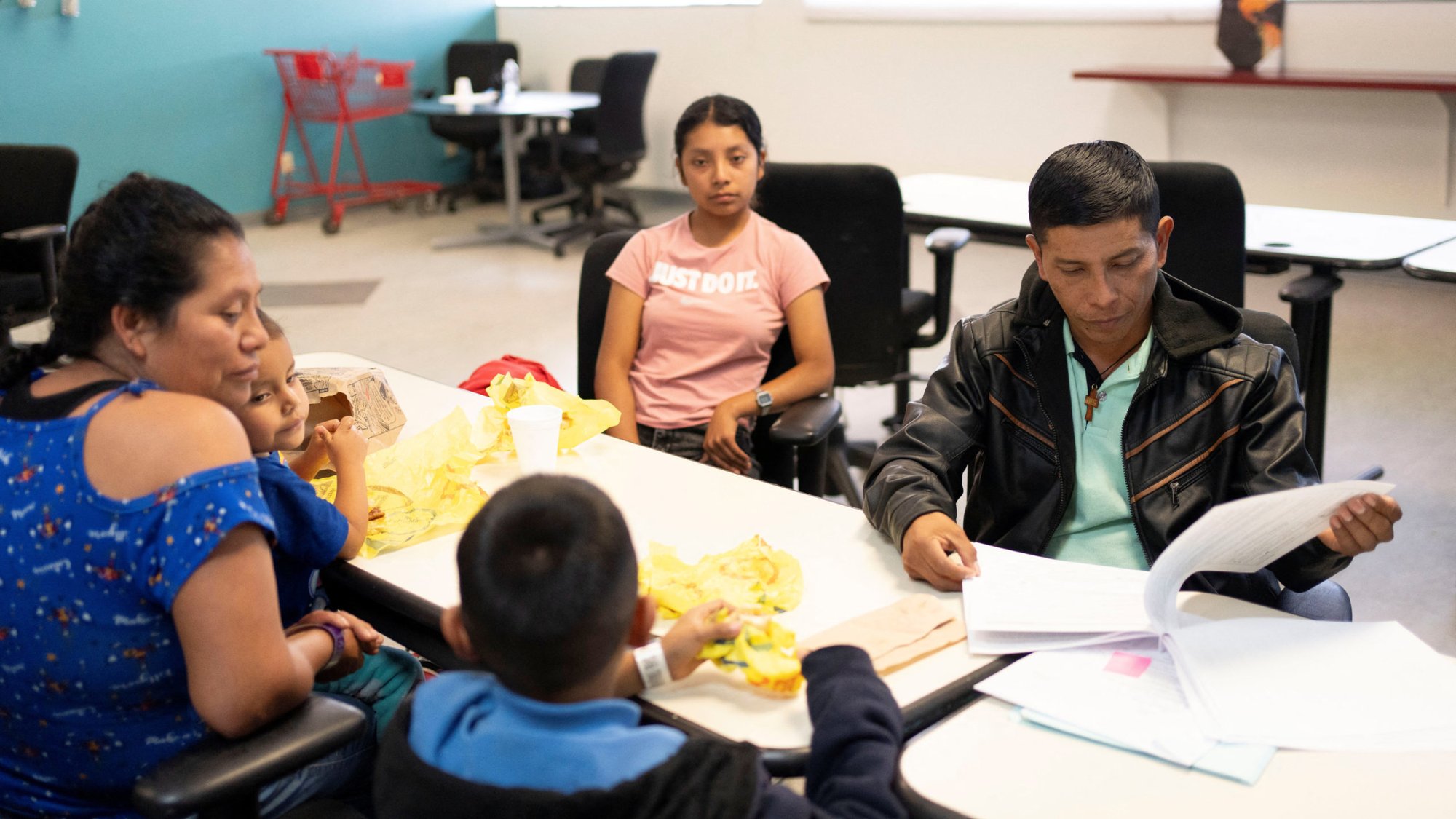 A migrant from Chiapas, Mexico, looks through his family's immigration paperwork at Casa Alitas in Tucson, Ariz., March 15, 2024. A federal judge in Texas Aug. 26, halted a Biden administration program that gives a pathway to legalization and citizenship for certain undocumented spouses and children of U.S. citizens. (OSV News/Rebecca Noble, Reuters)