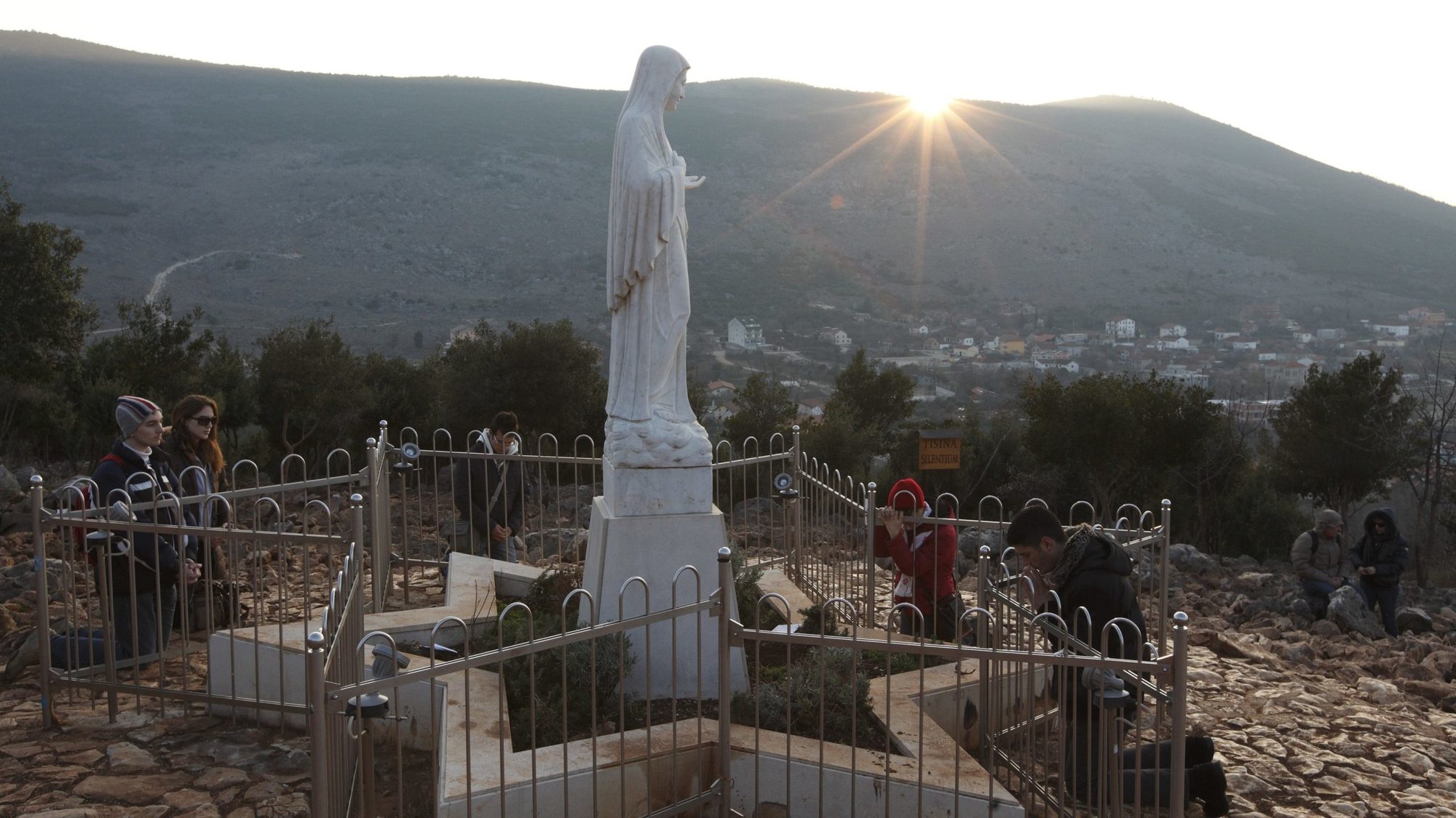 Pilgrims pray around a statue of Mary on Apparition Hill in Medjugorje, Bosnia-Herzegovina, in this 2011 file photo. (CNS photo/Paul Haring) See FISICHELLA-MARIAN-SHRINES Aug. 16, 2019.