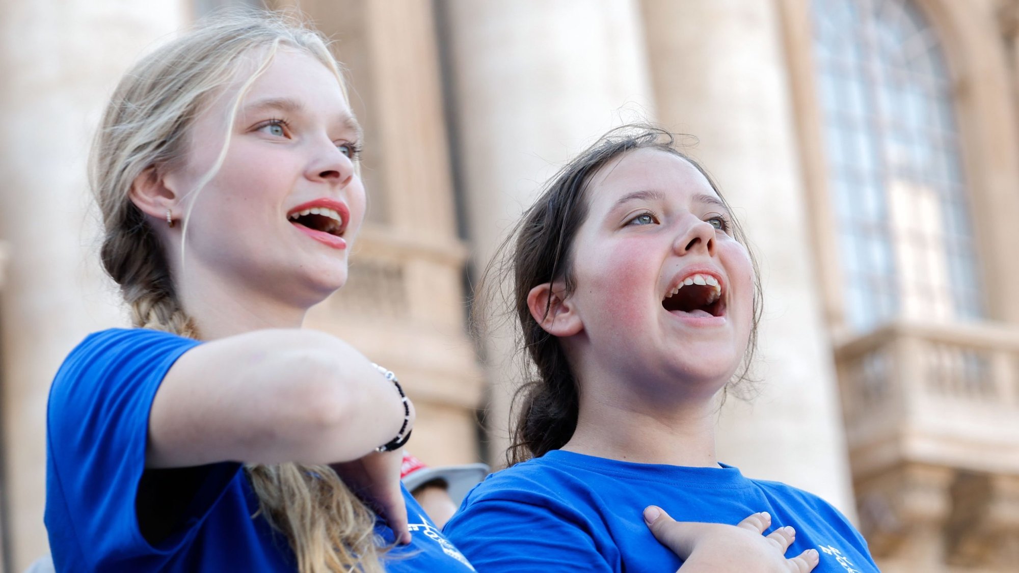 Two young women sing during a meeting with Pope Francis in St. Peter's Square at the Vatican July 30, 2024. Around 50,000 altar servers from 20 countries were on a pilgrimage to Rome. (CNS photo/Lola Gomez)