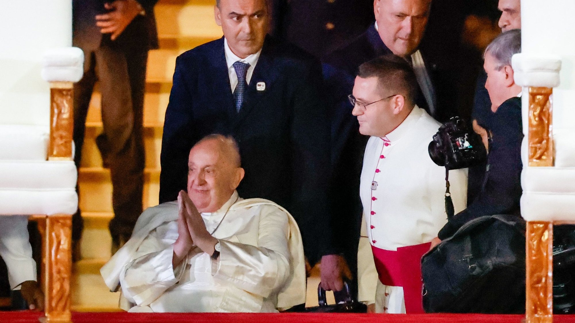 Pope Francis folds his hands in a gesture of gratitude as he approaches a platform at Jacksons International Airport for an official welcome ceremony in Port Moresby, Papua New Guinea, Sept. 6, 2024. (CNS photo/Lola Gomez)