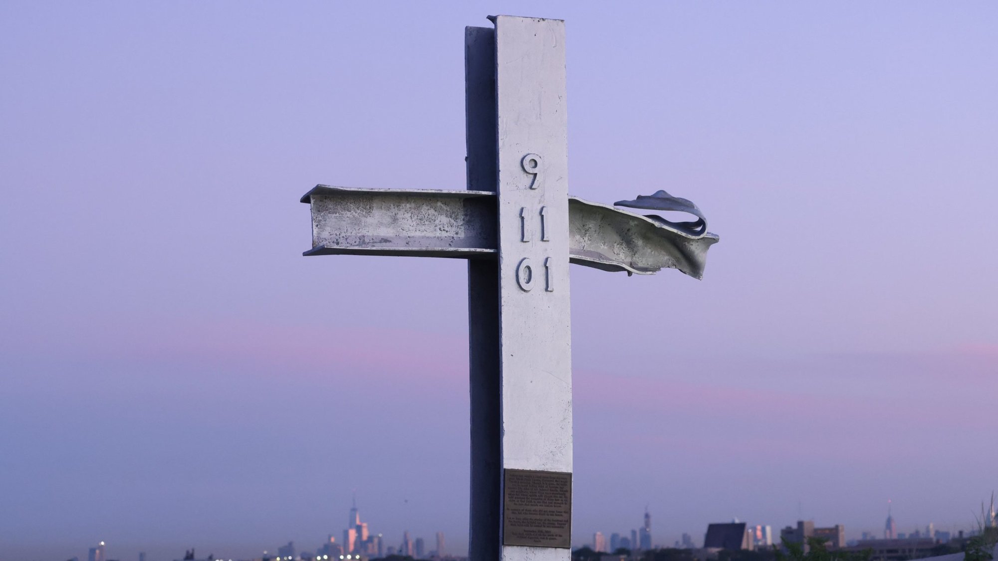 A cross made of steel from one of the fallen towers of the One World Trade Center is seen at sunrise Sept. 11, 2021, at New York's Breezy Point 9/11 Memorial on the day marking the 20th anniversary of the Sept. 11, 2001, attacks. (OSV News photo/Caitlin Ochs, Reuters)