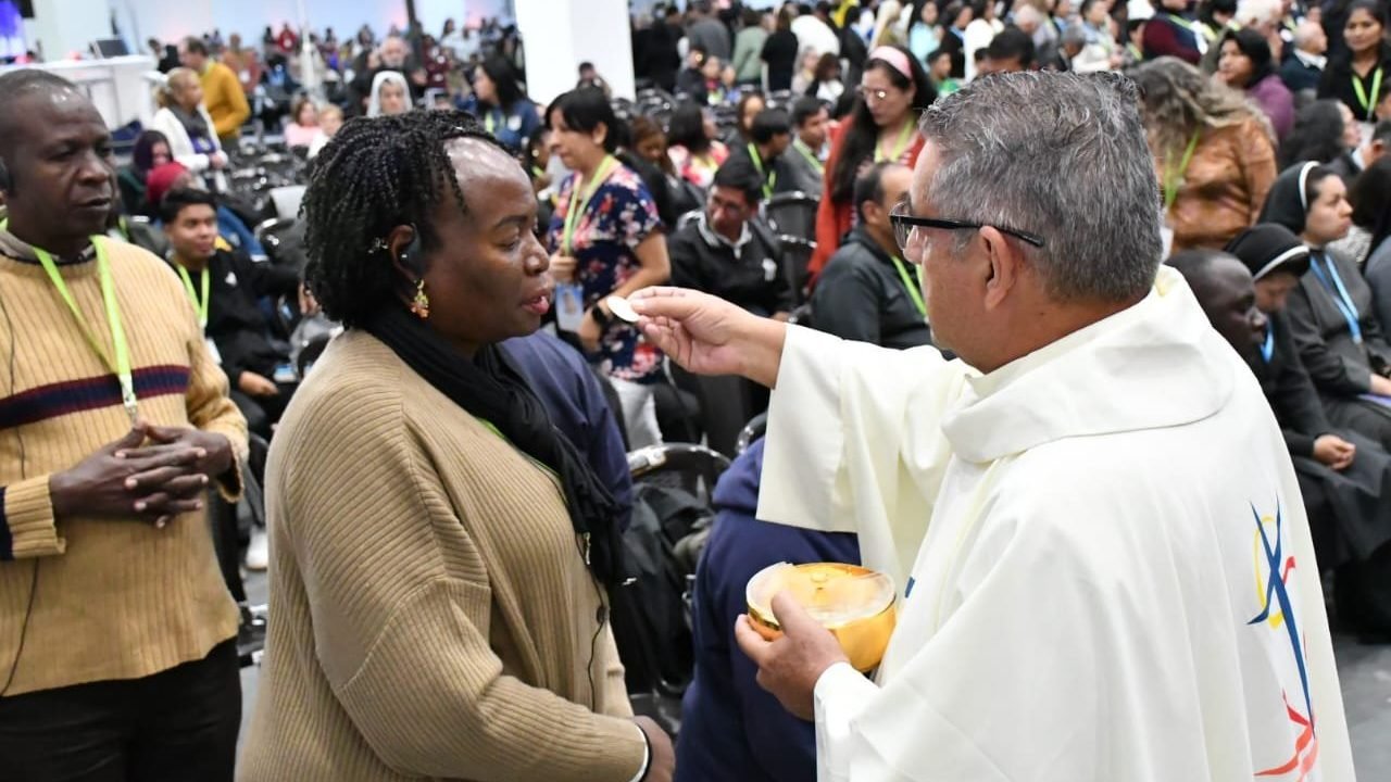 A woman receives Communion during Mass Sept. 10, 2024, at the International Eucharistic Congress in Quito, Ecuador. The Sept. 8-15 congress focused on a call to build fraternity as a way of healing the wounds of a world full of fractures and violence. (OSV News photo/courtesy International Eucharistic Congress)