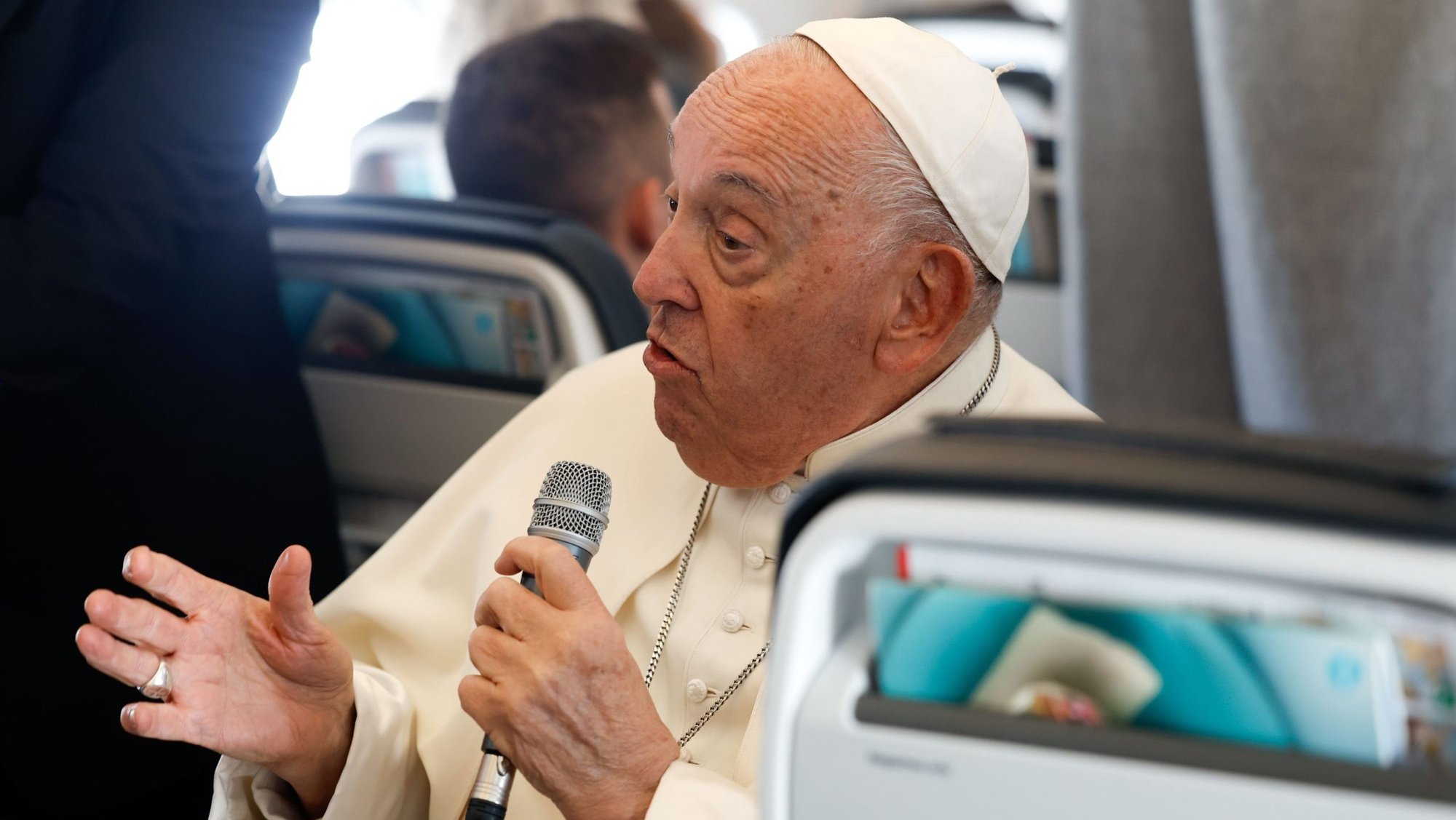 Pope Francis answers a question from a journalist aboard his flight back to Rome Sept. 29, 2024, after visiting Luxembourg and Belgium during his 46th international trip. (CNS photo/Lola Gomez)