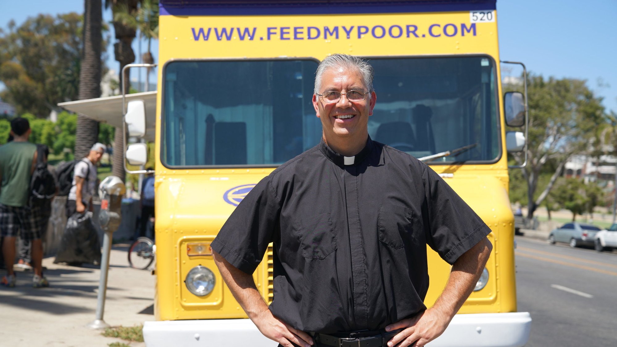 Father Ed Benioff, pastor at Church of the Good Shepherd in Beverly Hills, stands in front of the Feed My Poor food truck that brings hot meals to the needy seven days a week. (John Rueda)