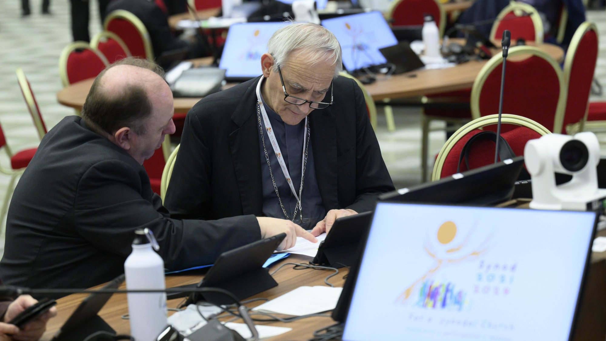 Cardinal Matteo Zuppi of Bologna, president of the Italian bishops' conference, looks over a text before the start of a working session of the Synod of Bishops Oct. 4, 2024, in the Paul VI Audience Hall at the Vatican. (CNS photo/Vatican Media)