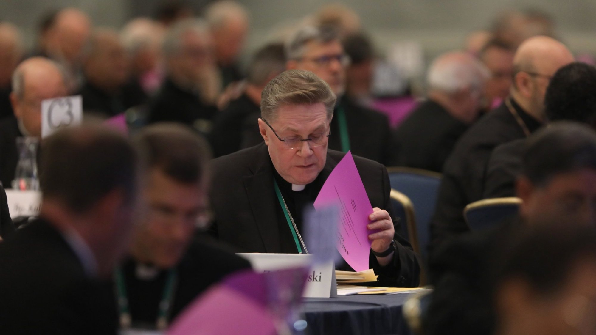 Auxiliary Bishop Andrzej J. Zglejszewski of Rockville Centre, N.Y., looks over paperwork during a Nov. 15, 2023, session of the fall general assembly of the U.S. Conference of Catholic Bishops in Baltimore. (OSV News photo/Bob Roller)