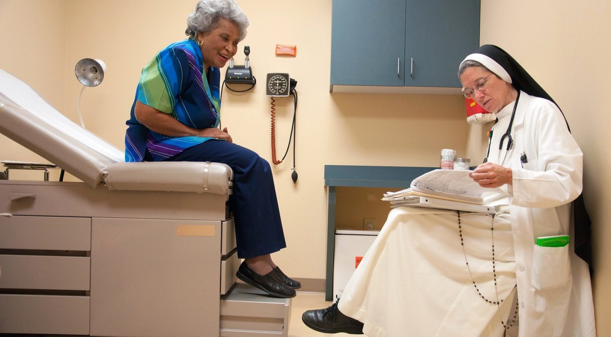 Dominican Sister Mary Diana Dreger, a medical doctor, is pictured in a file photo talking with a patient at St. Thomas Family Health Center South in Nashville, Tenn. (OSV News photo/Theresa Laurence, Tennessee Register)