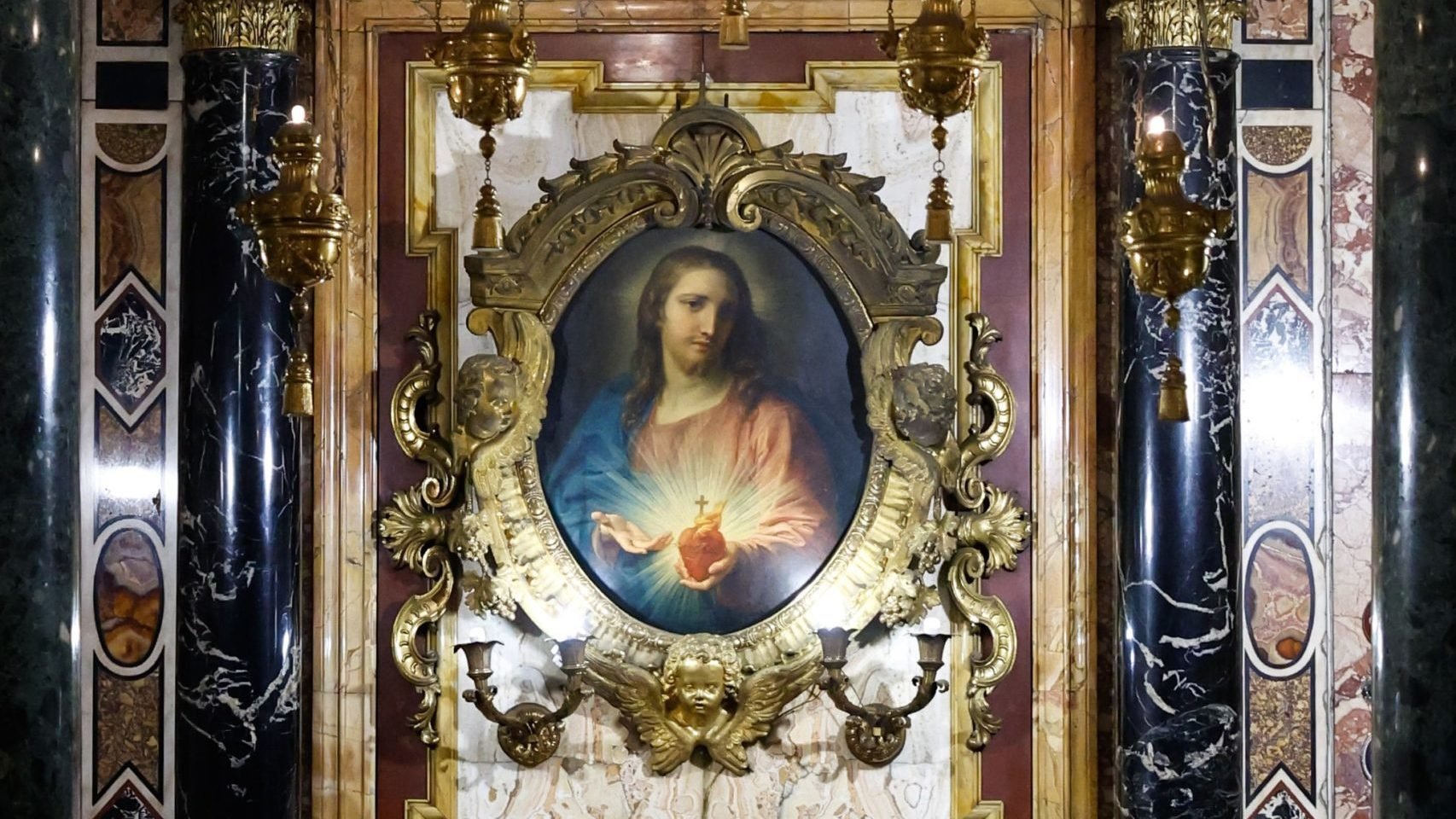 A painting by Pompeo Batoni of the Sacred Heart of Jesus from 1767 is displayed in an ornate frame inside the Jesuit Church of the Gesù in Rome, Oct. 22, 2024. (CNS photo/Lola Gomez)