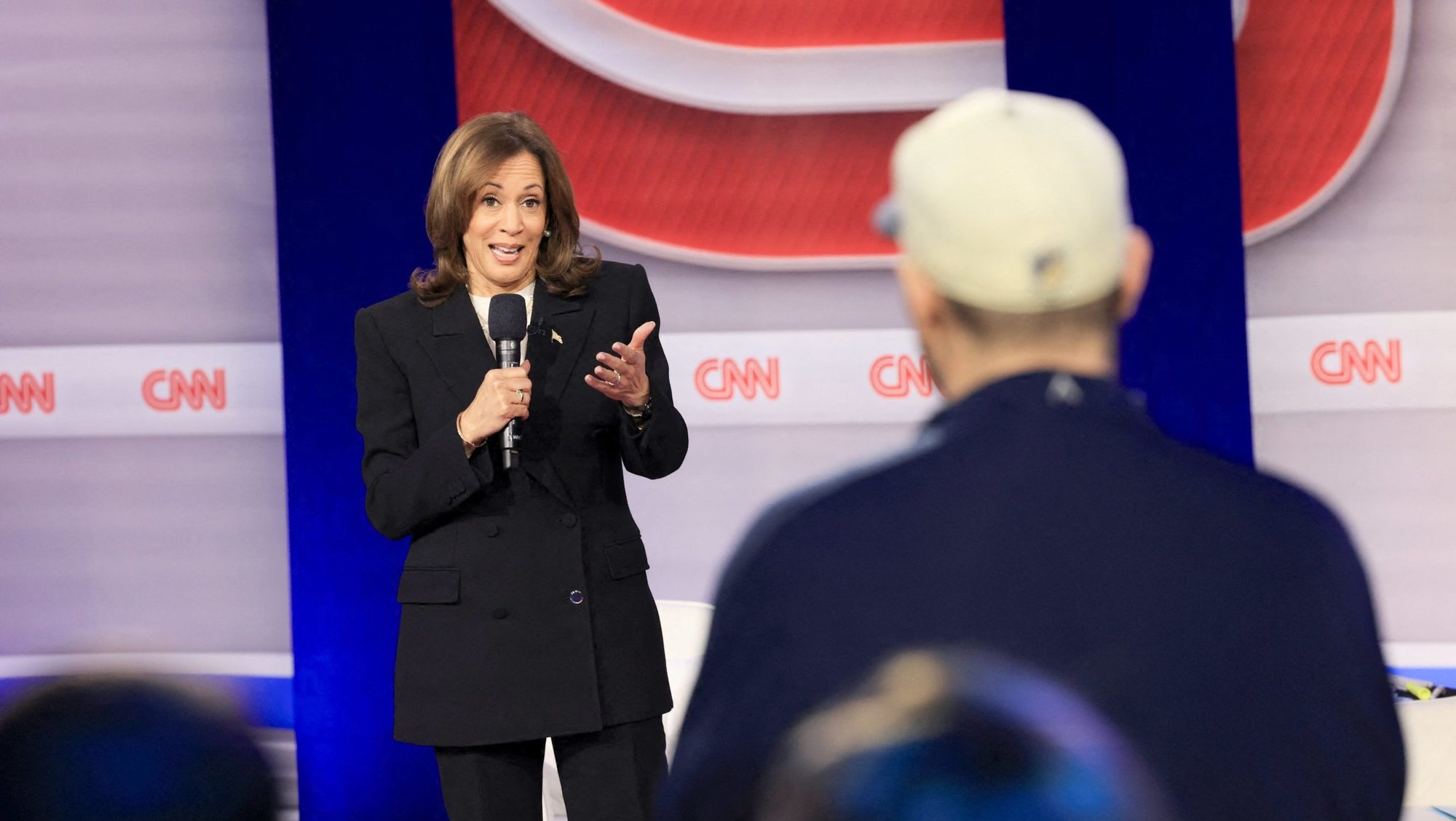 Vice President Kamala Harris, the Democratic presidential nominee, speaks to a man in the audience during a CNN town hall event in Aston, Pa., Oct. 23, 2024. After Harris said Oct. 22 she does not think "concessions" should be made on codifying abortion protections, some pro-life activists expressed concern that a potential Harris administration would not implement religious exemptions to abortion policy. (OSV News photo/Nicole Neri, Reuters) (OSV News photo/Kevin Mohatt, Reuters)