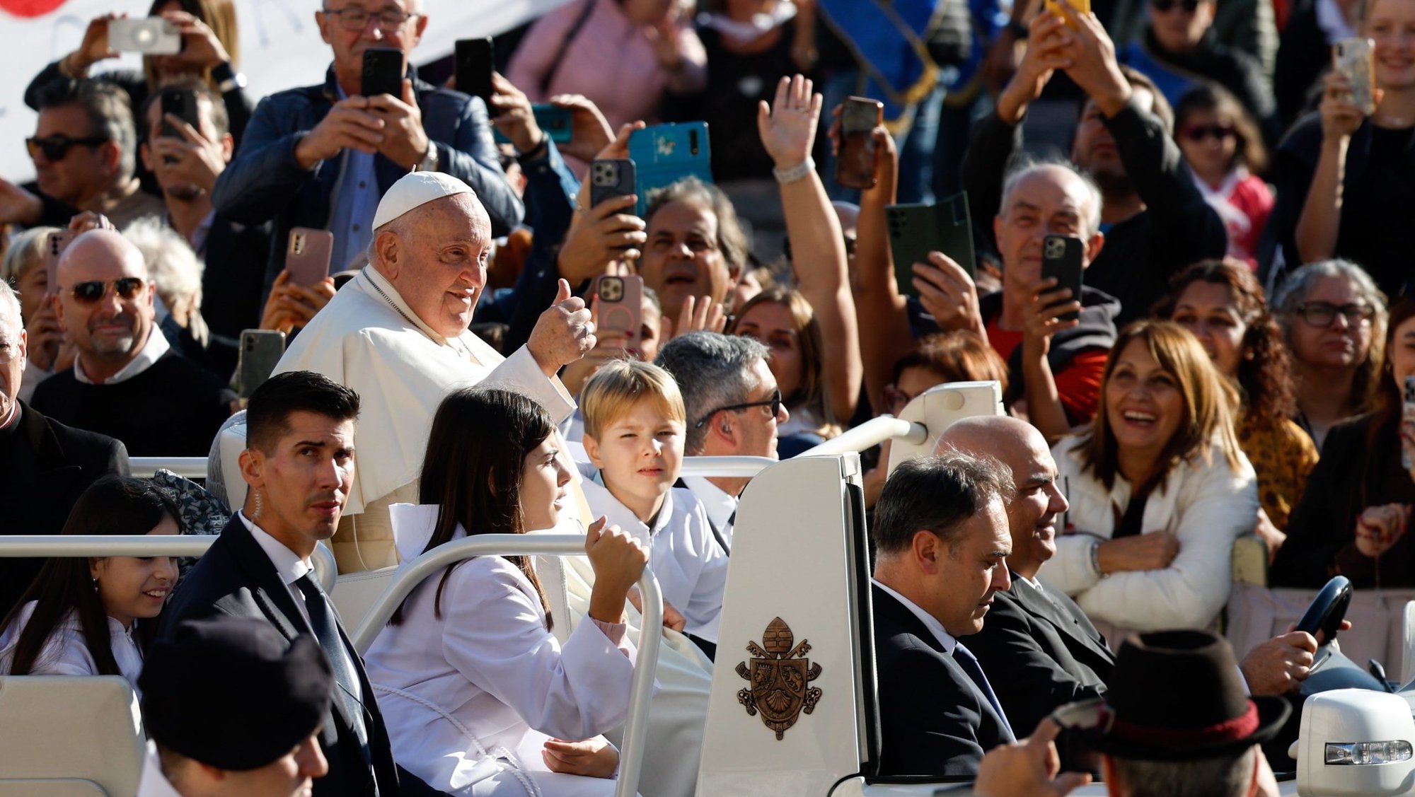Pope Francis greets visitors as he rides the popemobile around St. Peter's Square at the Vatican before his weekly general audience Oct. 30, 2024. (CNS photo/Lola Gomez)