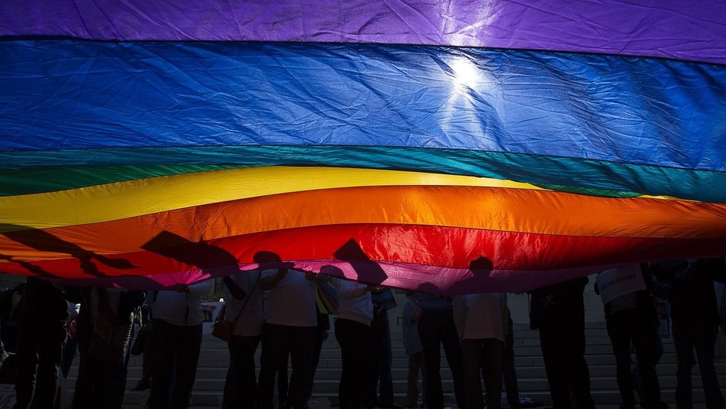 In this 2015 file photo, LGBTQ supporters wave a flag outside the U.S. Supreme Court in Washington. (OSV News photo/Tyler Orsburn, CNS archive)