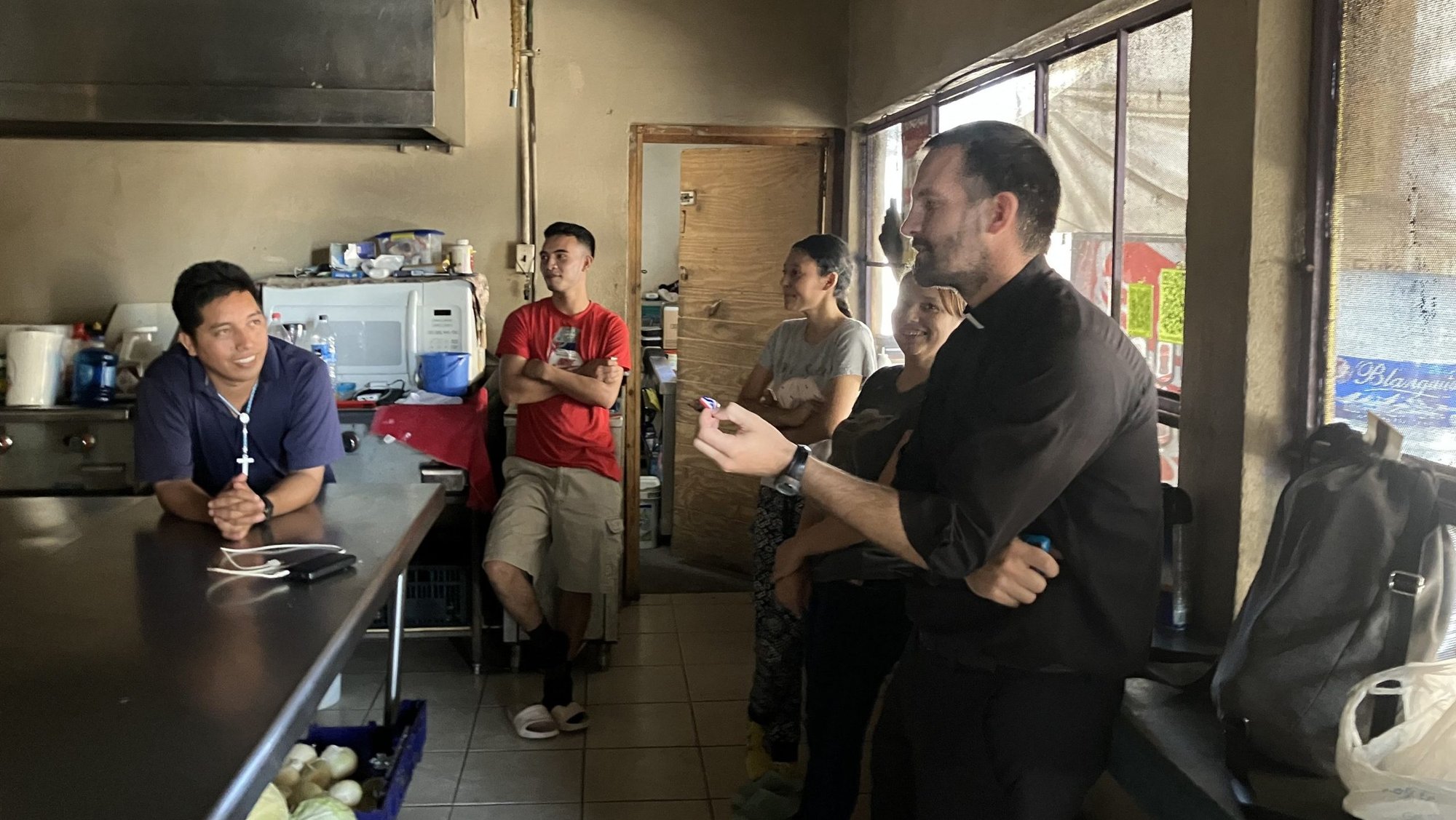 Jesuit Father Brian Strassburger speaks with migrants Oct. 15, 2024, at the Senda de Vida shelter in Reynosa, Mexico. Migrants at the shelter have expressed worry over not being able to enter the United States after the election of President-elect Donald Trump. (OSV News photo/David Agren)