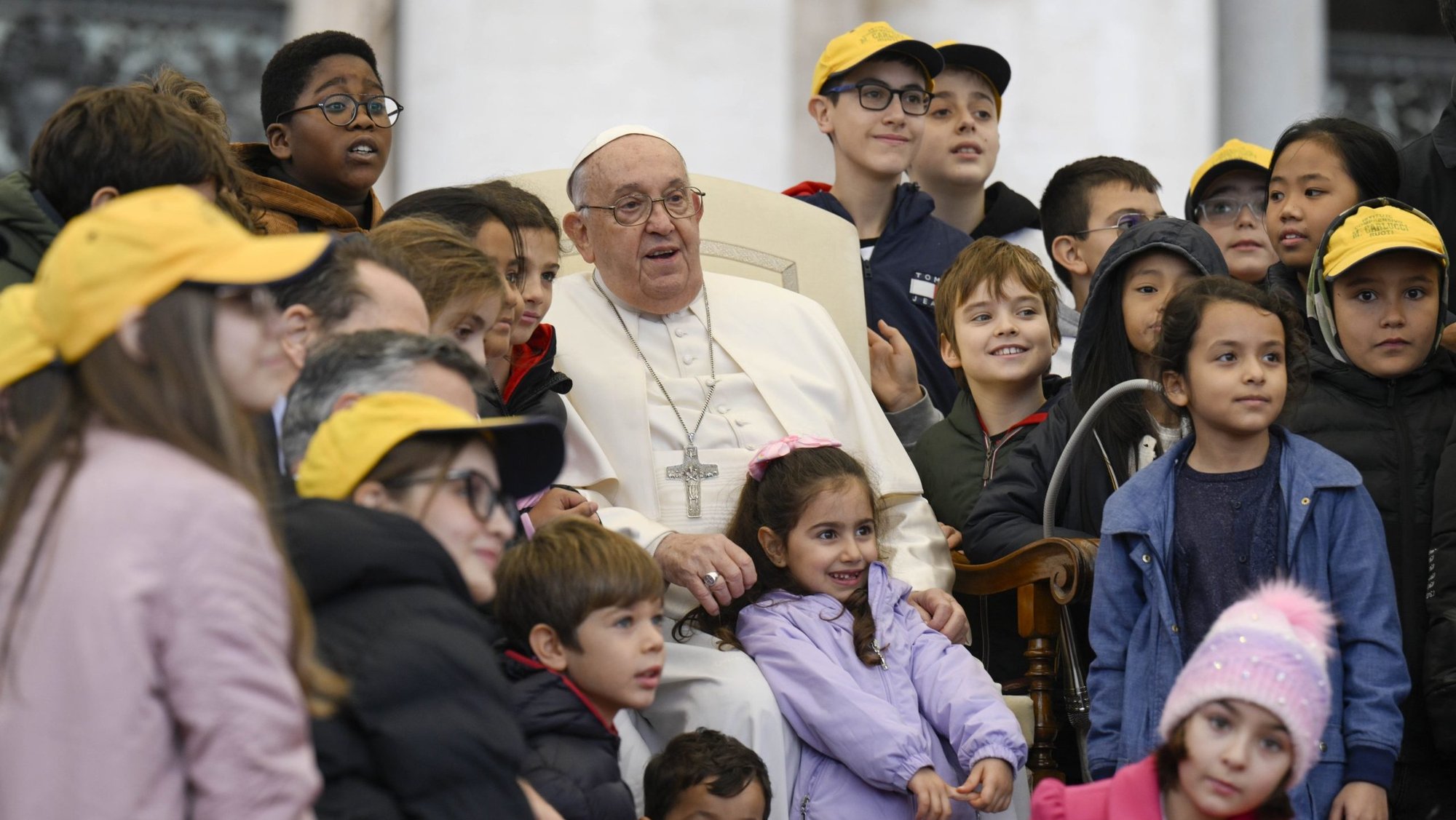 Pope Francis poses with a group of children during his weekly general audience in St. Peter's Square at the Vatican Nov. 20, 2024. (CNS photo/Vatican Media)