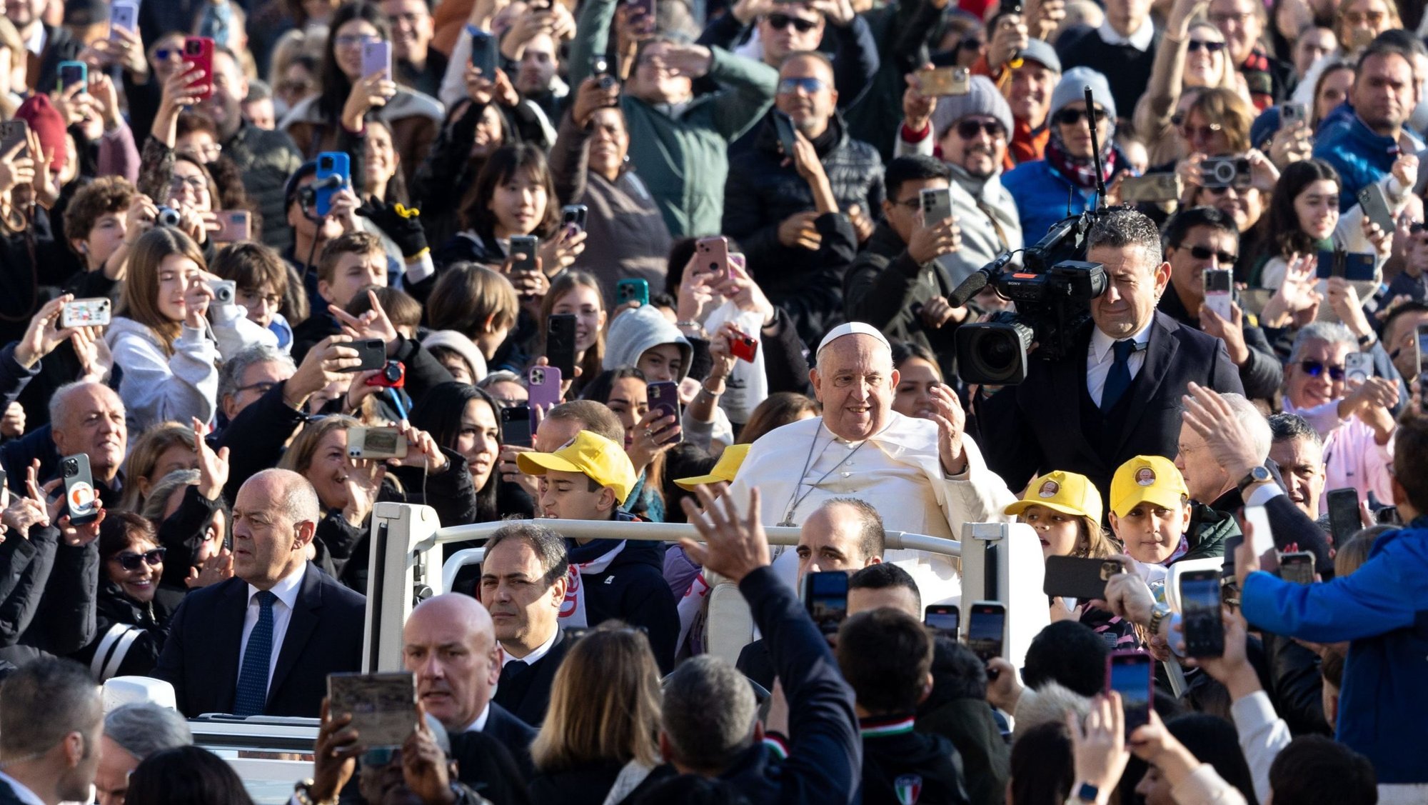 Pope Francis greets visitors as he rides the popemobile around St. Peter's Square before his weekly general audience at the Vatican Nov. 27, 2024. (CNS photo/Lola Gomez)