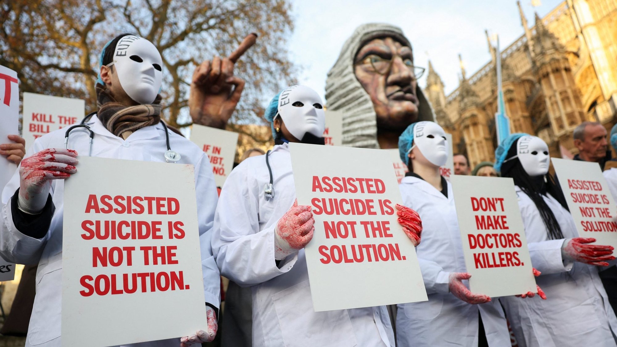Protestors holds a placard outside Parliament as British lawmakers debate the assisted dying law in London Nov. 29, 2024. Britain's lawmakers voted Nov. 29 to legalize assisted suicide for the terminal ill in England and Wales, despite opposition from Britain's Catholic bishops and other faith groups. (OSV News photo/Mina Kim, Reuters)
