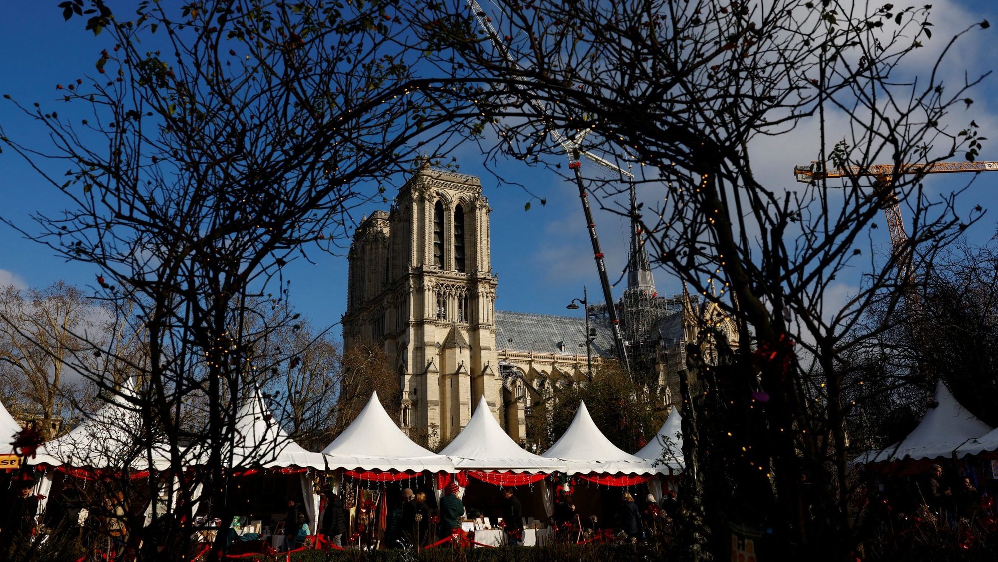 A Christmas market is seen along the banks of the Seine River in Paris Dec. 4, 2024, near Notre Dame Cathedral, which was ravaged by a fire in 2019. Restoration work continued before the Dec. 7-8 reopening ceremonies. (OSV News photo/Stephanie Lecocq, Reuters)