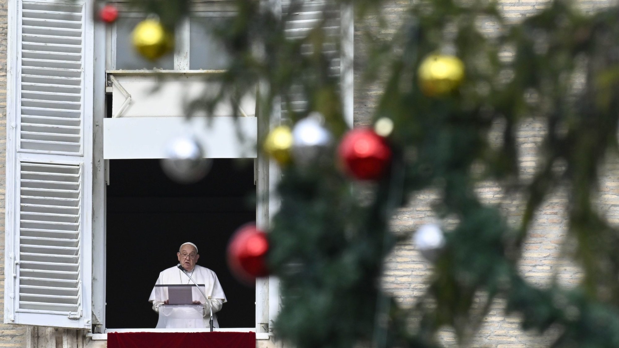 Pope Francis speaks to visitors joining him for the recitation of the Angelus prayer in St. Peter's Square at the Vatican Dec. 8, 2024. (CNS photo/Vatican Media)