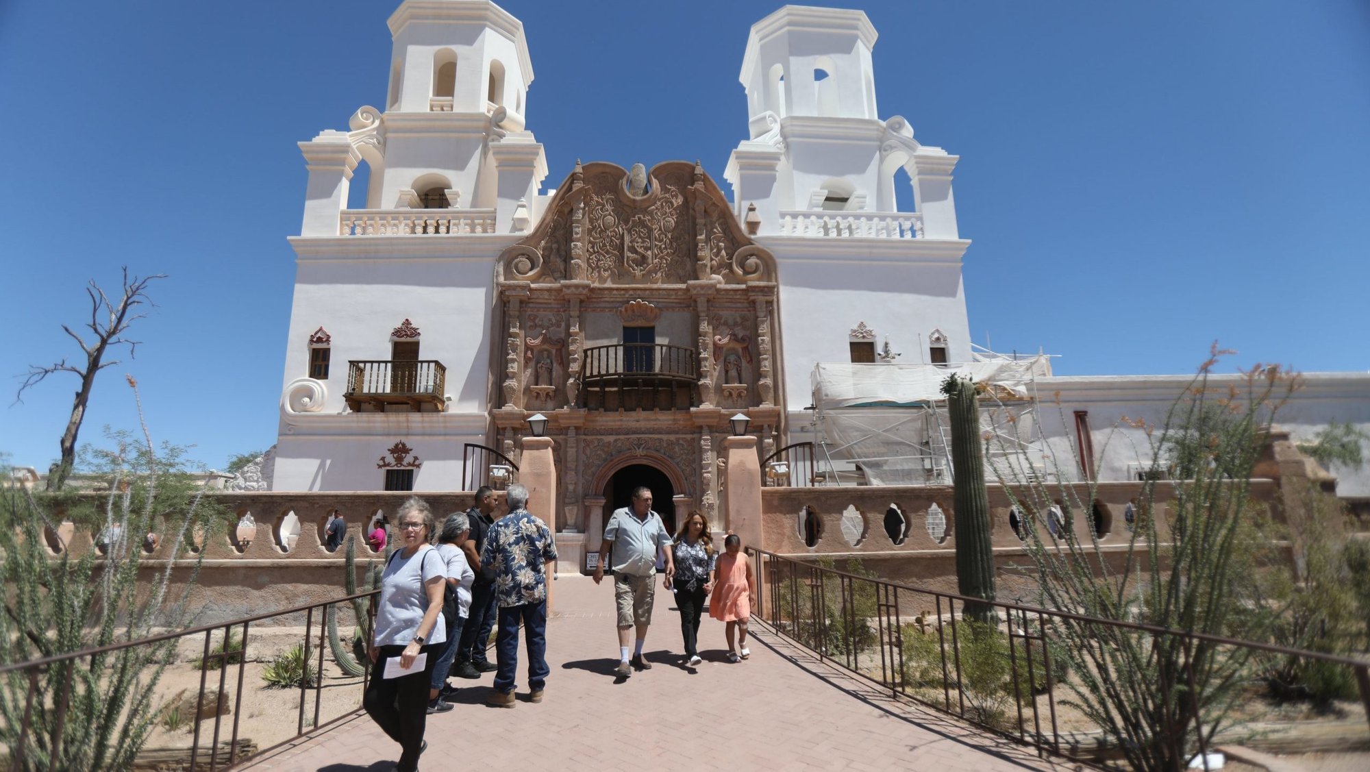 After attending Mass, people leave San Xavier del Bac Mission in Pima County, Ariz., outside Tucson, May 28, 2023. Ten state faith leaders -- including Catholic Bishops Edward J. Weisenburger of Tucson and John P. Dolan of Phoenix -- wrote an op-ed column published Dec. 28, 2024, in the Arizona Republic, denouncing reported proposals to allow immigration raids on churches, houses of worship, hospitals, schools and other locations currently deemed off-limits due to their sensitive nature once President-elect Donald Trump takes office. (OSV News photo/Bob Roller)