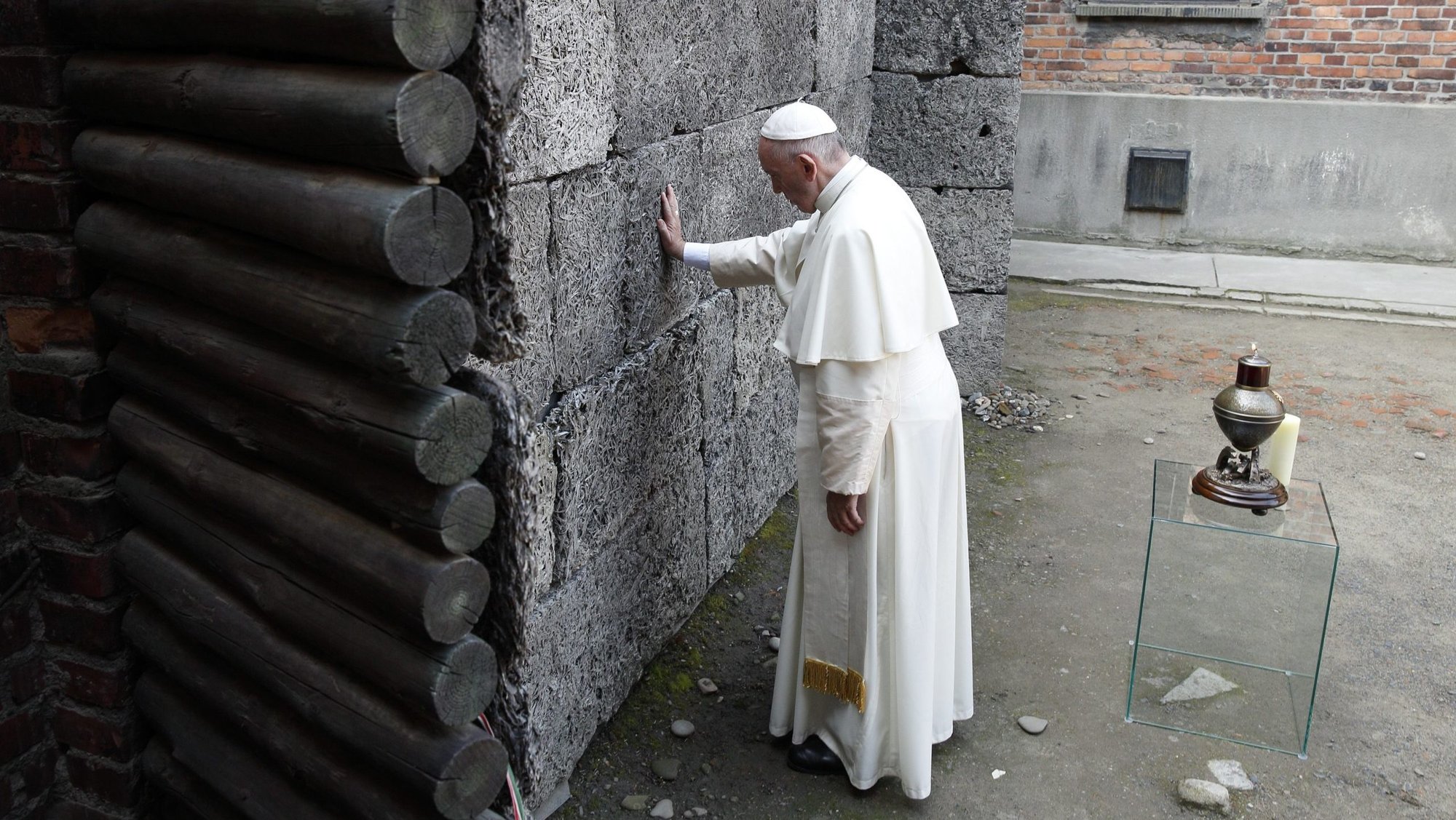 Pope Francis touches the death wall at the Auschwitz Nazi death camp in Oswiecim, Poland, in this July 29, 2016, file photo. The pope said remembering the Holocaust and its victims is not only an "expression of humanity" but also makes people aware that such horrors may happen again. The pope's comments came at his general audience as he commemorated International Holocaust Remembrance Day Jan. 27. (CNS photo/Paul Haring)