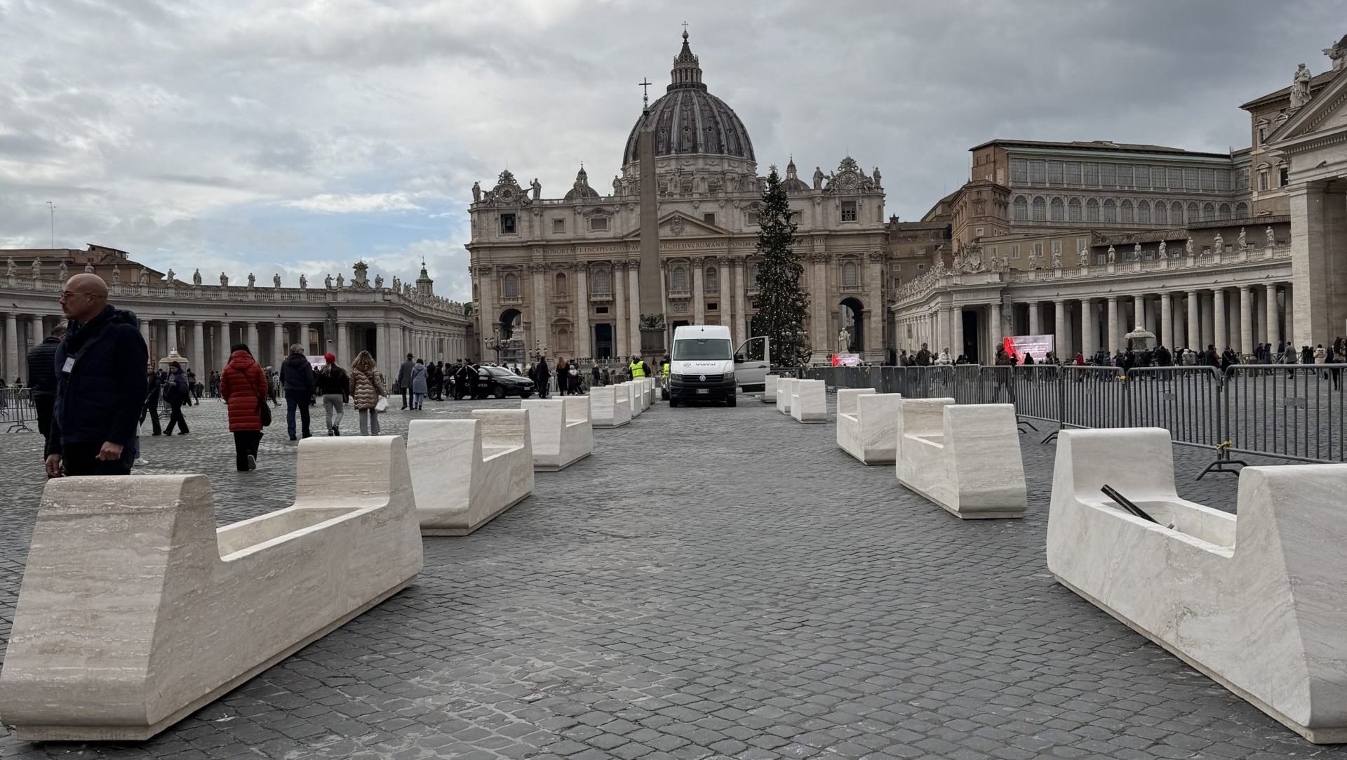 Less than two weeks before Pope Francis opens the Holy Door of St. Peter's Basilica at the Vatican on Christmas Eve, workers set out large planters Dec. 13, 2024, to mark a reserved path to the door for Holy Year pilgrims. (CNS photo/Cindy Wooden)
