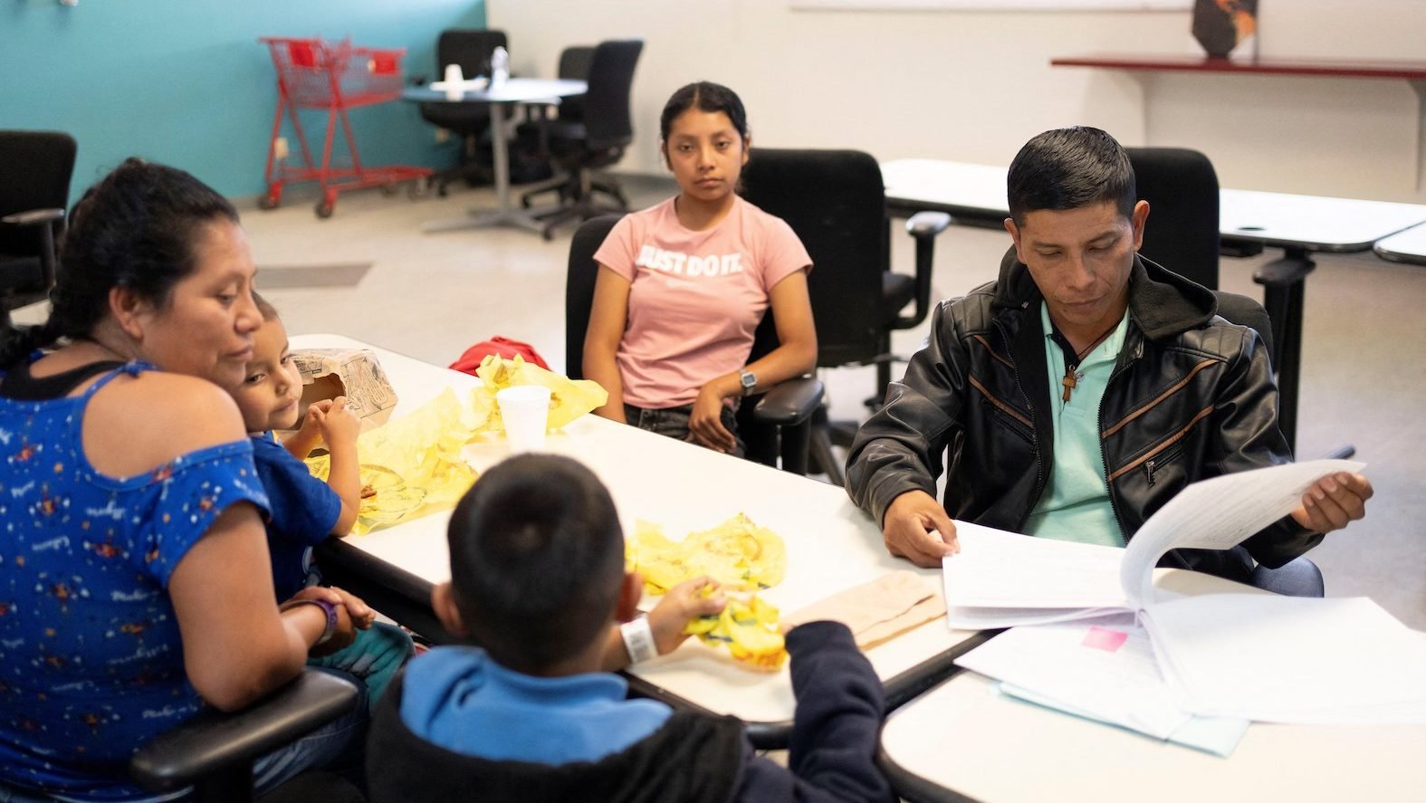 A migrant from Mexico's Chiapas state looks through his family's immigration paperwork at Casa Alitas in Tucson, Ariz., March 15, 2024. A federal judge in Texas Nov. 7 struck down a Biden administration program that gave a pathway to legal status and citizenship for U.S. citizens' spouses in the country without authorization and the couples' children. (OSV News photo/Rebecca Noble, Reuters)
