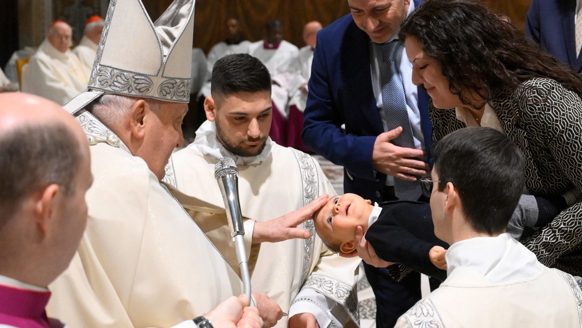 Pope Francis baptizes a baby during Mass in the Sistine Chapel at the Vatican Jan. 12, 2025, the feast of the Baptism of the Lord. (CNS photo/Vatican Media)