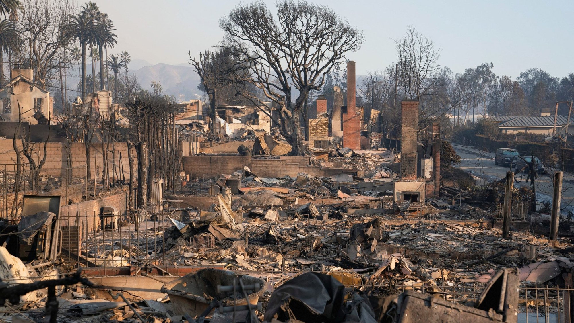 The remains of homes are seen Jan. 10, 2025, following the Palisades Fire in Los Angeles. As of late Jan. 14, the death toll numbered at least 25 people, but with several wildfires raging, officials warn the actual toll will remain unclear until it's safe for investigators to access neighborhoods. Tens of thousands of people have been impacted by evacuation orders since the blazes began Jan. 7. (OSV News photo//David Ryder, Reuters)
