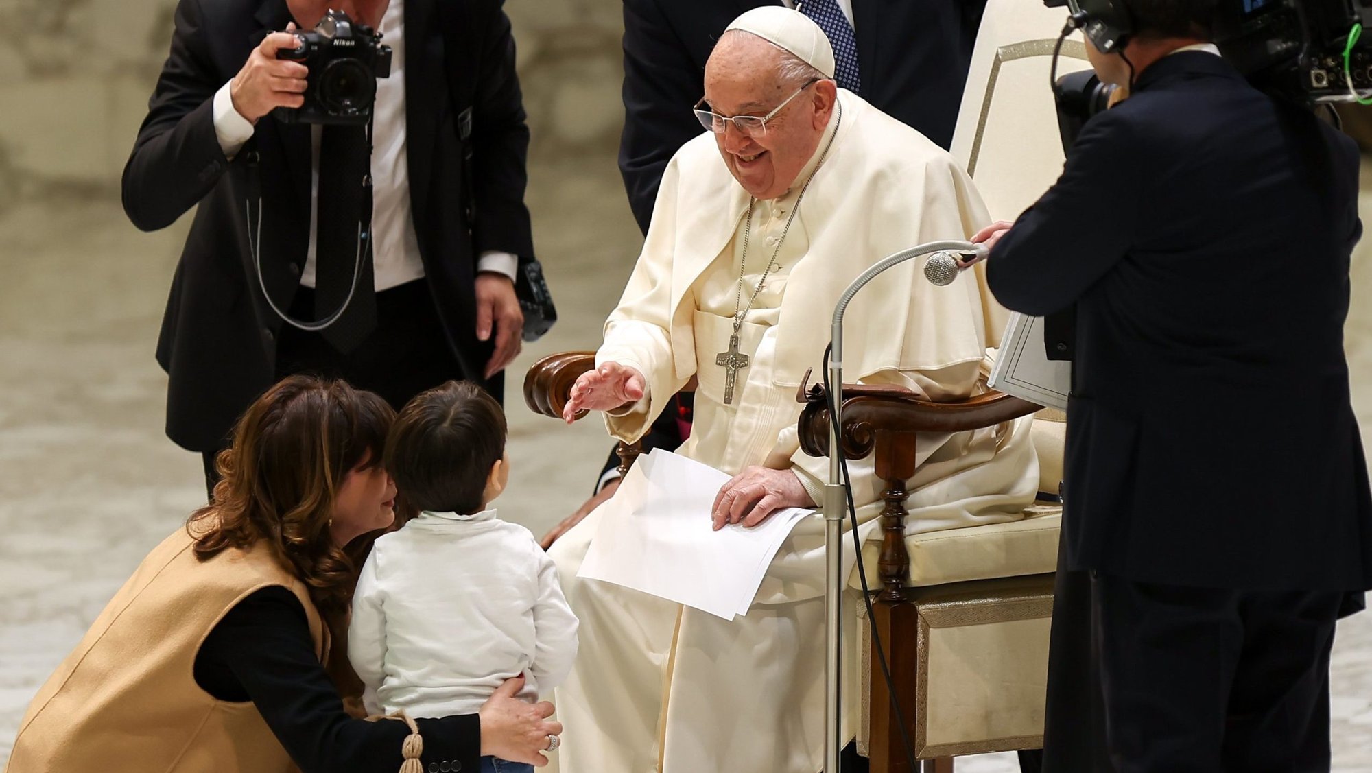 Pope Francis greets a child at the conclusion of his weekly general audience in the Paul VI Audience Hall at the Vatican Jan. 15, 2025. (CNS photo/Lola Gomez)