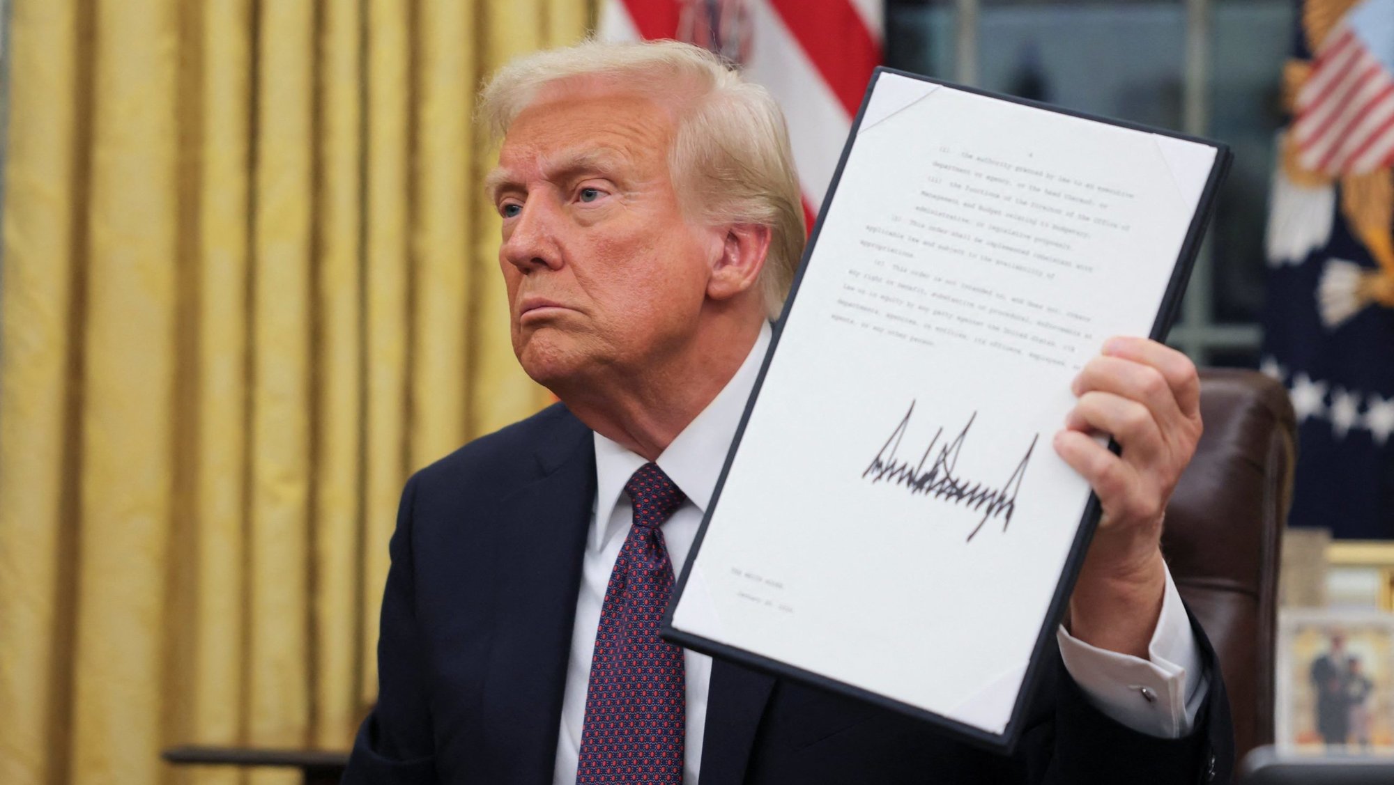U.S. President Donald Trump signs documents in the Oval Office at the White House on Inauguration Day in Washington Jan. 20, 2025. (OSV News photo/Carlos Barria, Reuters)