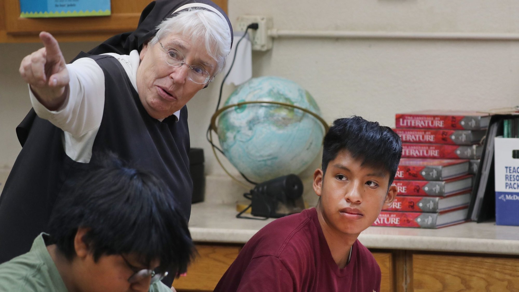 Sister Martha Mary Carpenter, principal at St. Peter Indian Mission Catholic School on the Gila River Indian Reservation in Bapchule, Ariz., works with a student during boys seventh and eight-grade math class Sept. 4, 2024. (OSV News photo/Bob Roller)