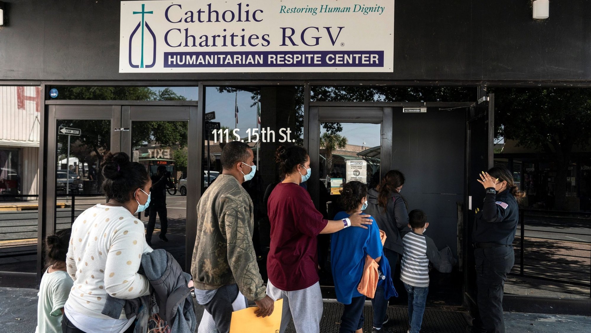 Migrants seeking asylum in the U.S. walk into a temporary humanitarian respite center run by Catholic Charities of the Rio Grande Valley in McAllen, Texas, April 8, 2021. (CNS photo/Go Nakamura, Reuters)