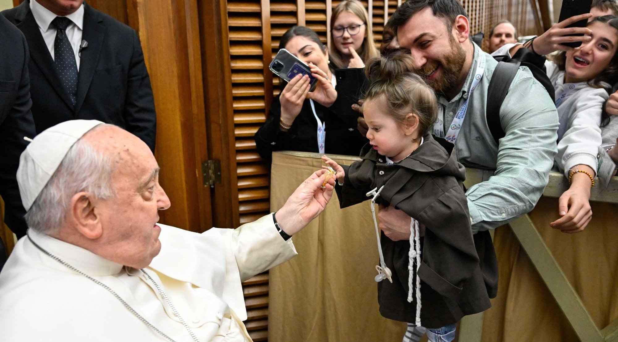 Pope Francis greets a child during a meeting with a pilgrimage group from Scandinavia in the Paul VI Audience Hall at the Vatican Feb. 3, 2025. (CNS photo/Vatican Media)