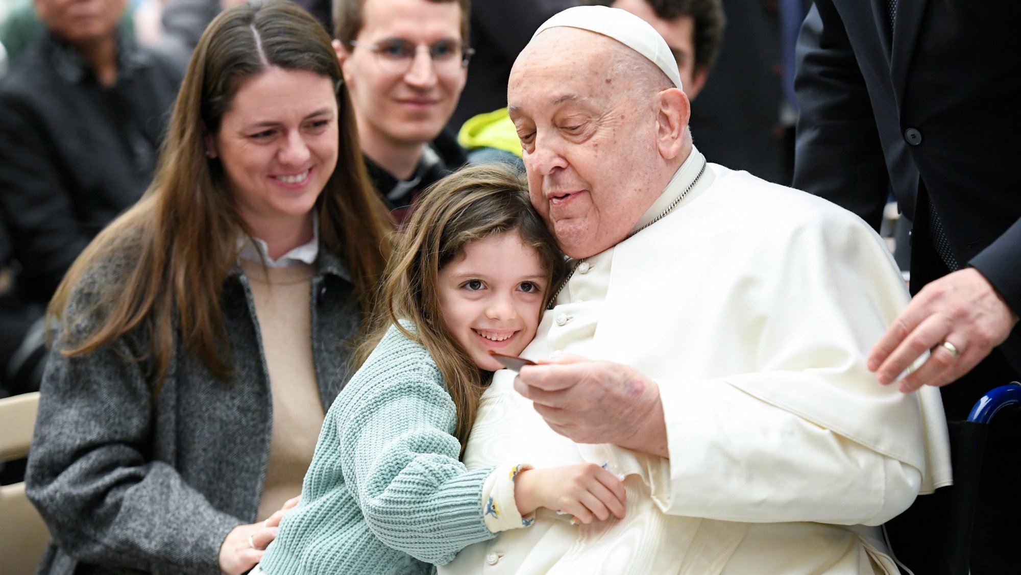 Pope Francis greets a child at the conclusion of his weekly general audience in the Paul VI Audience Hall at the Vatican Feb. 12, 2025. (CNS photo/Vatican Media)
