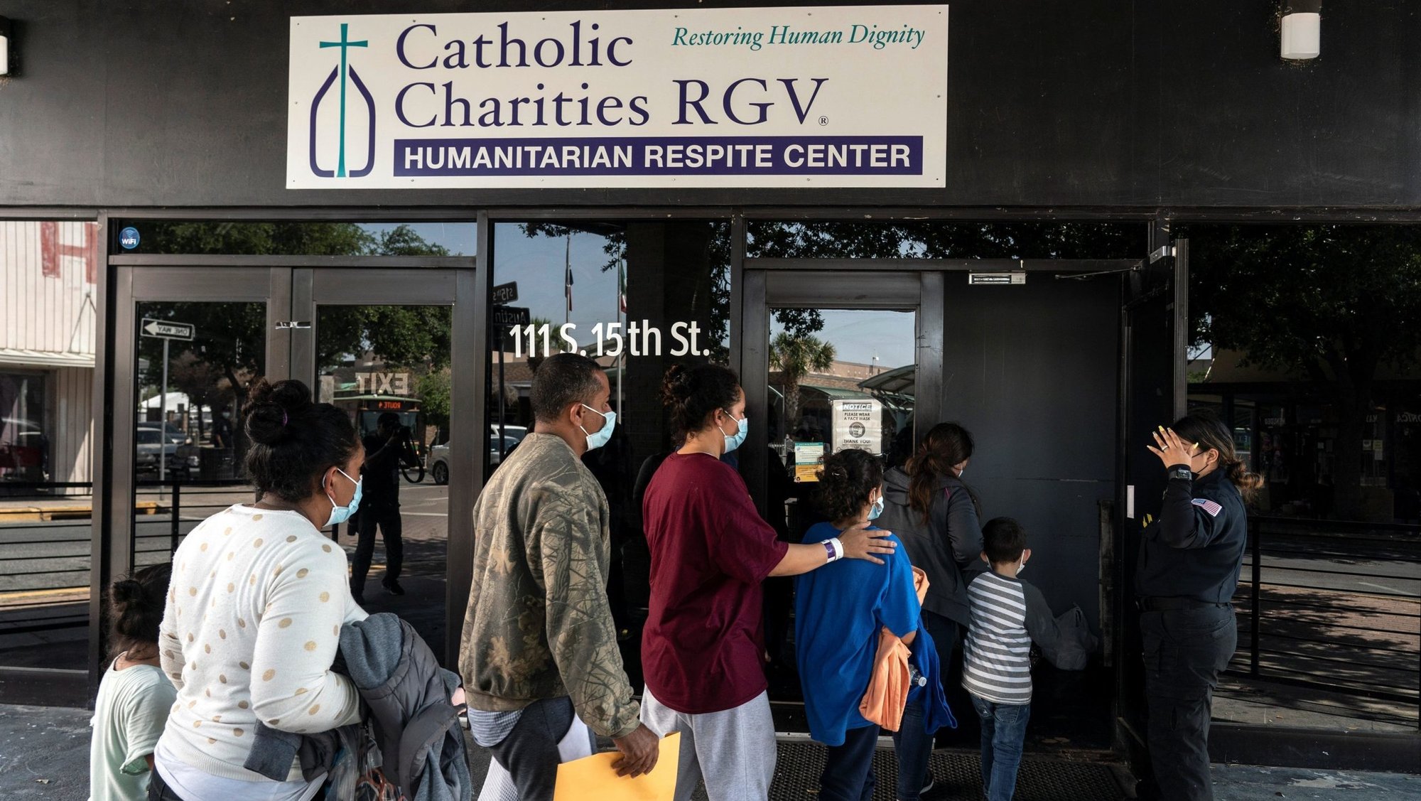 Migrants seeking asylum in the U.S. walk into a temporary humanitarian respite center run by Catholic Charities of the Rio Grande Valley in McAllen, Texas, April 8, 2021. (OSV News photo/Go Nakamura, Reuters)