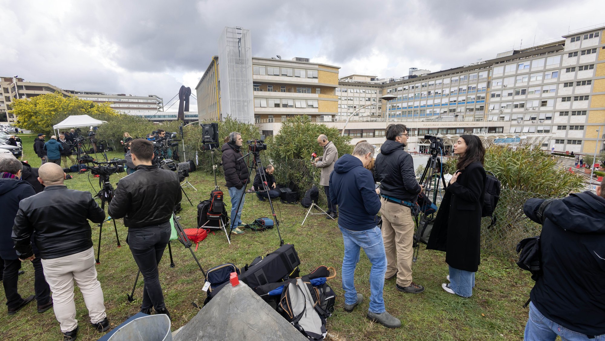 Reporters, television crews and photographers gather on a hillside at Rome's Gemelli hospital Feb. 14, 2025, after Pope Francis was admitted for tests and treatment of bronchitis. (CNS photo/Pablo Esparza)