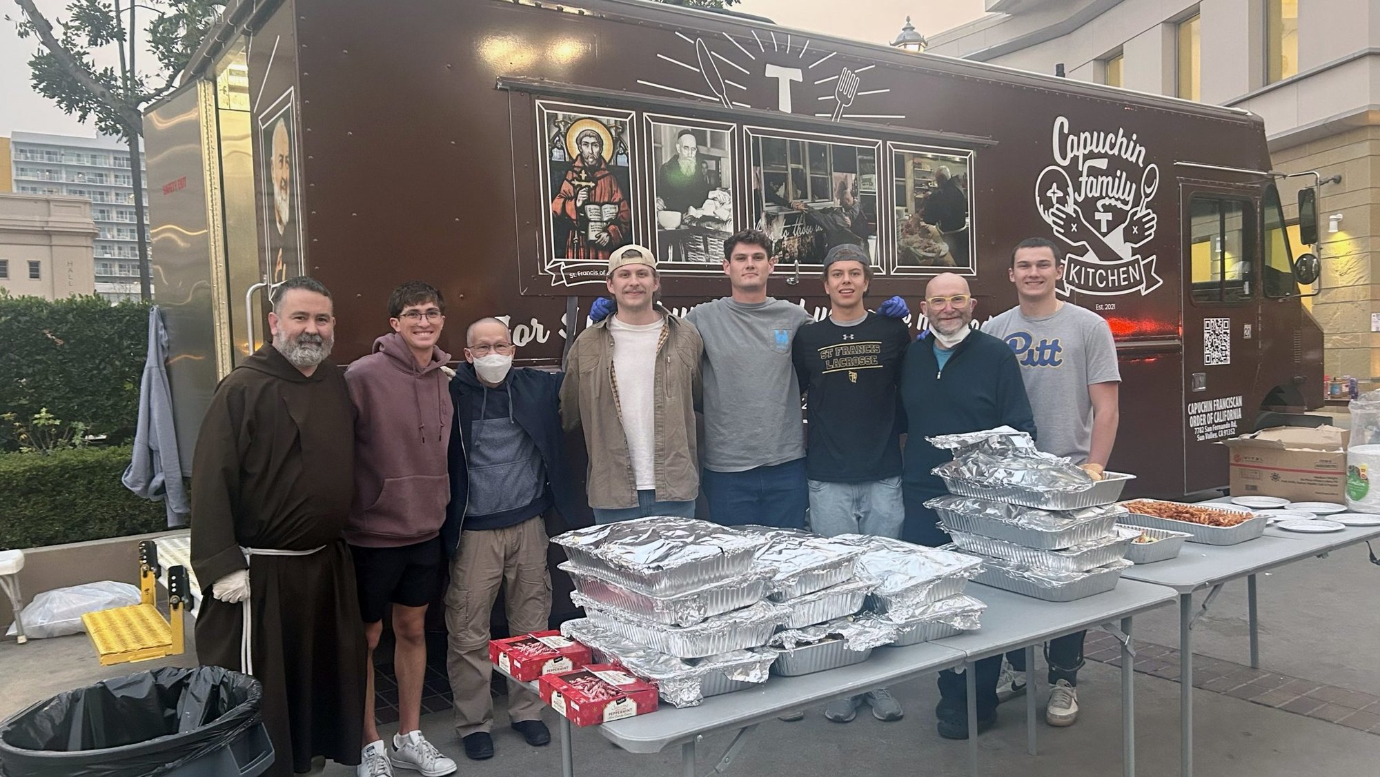 Capuchin Franciscan Father Christopher Iwancio stands with volunteers beside the "Capuchin Family Kitchen" food truck outside the Pasadena Convention Center in Pasadena, Calif., in this undated photo. (OSV News photo/courtesy of Fr. Christopher Iwancio, OFM Cap.)