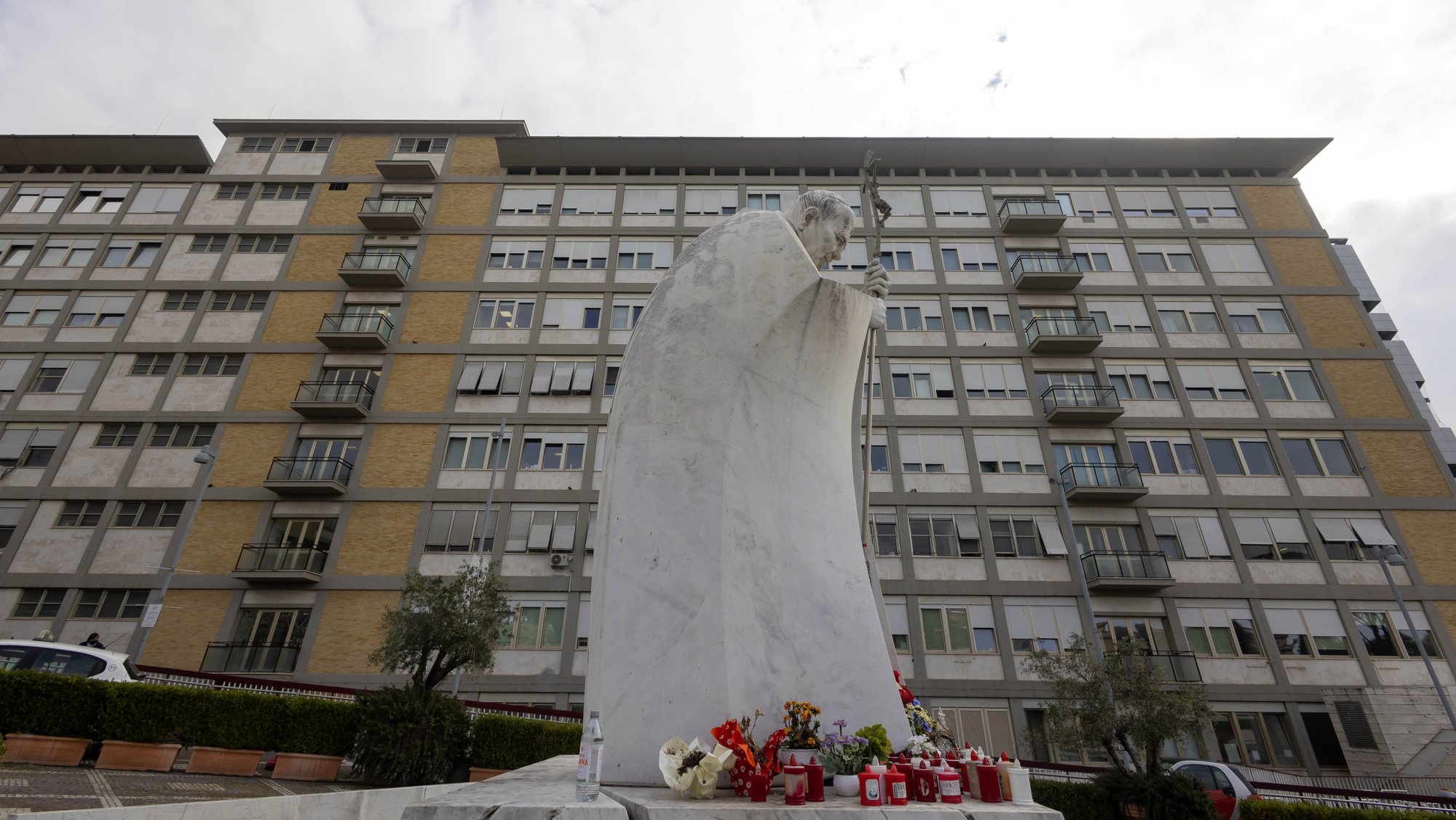 A statue of St. John Paul II stands outside Rome's Gemelli hospital Feb. 18, 2025. The suite of rooms where St. John Paul used to stay and where Pope Francis has been receiving treatment since Feb. 14 is on the top floor at the far left. (CNS photo/Pablo Esparza)